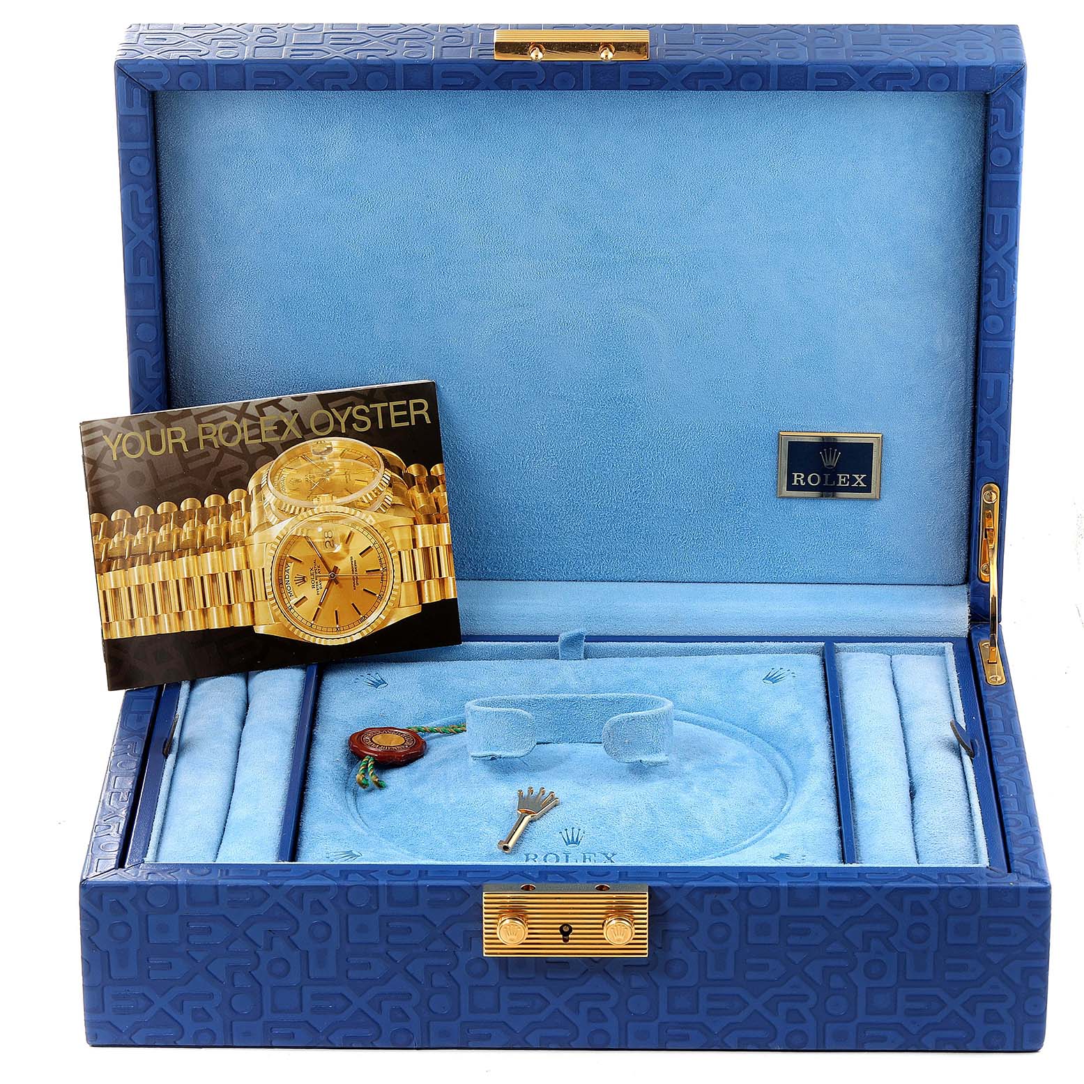The image shows a blue Rolex presentation box for the Pearlmaster model, including a brochure, a tag, and a crown-shaped accessory.
