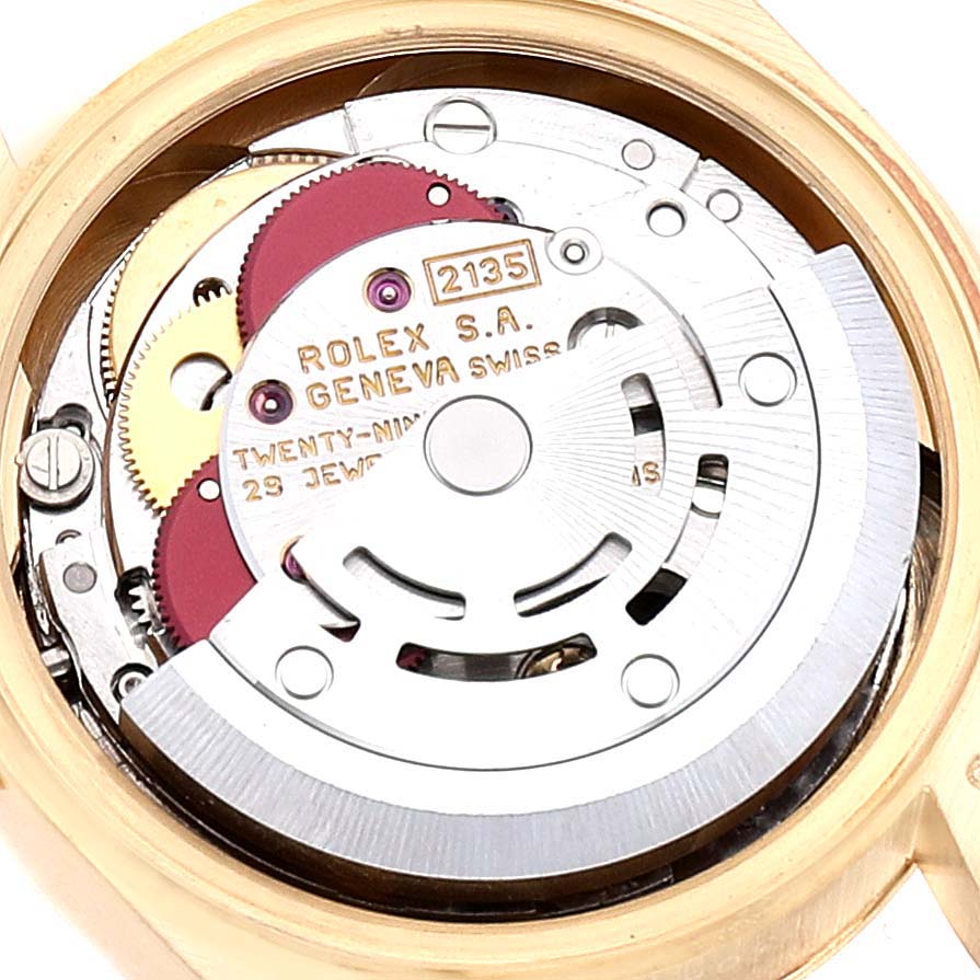 The image shows the internal mechanism of a Rolex President 69178 Women
s Yellow Gold Champagne Dial 69178 Women
s Yellow Gold Champagne Dial model, highlighting its gears and inscriptions.