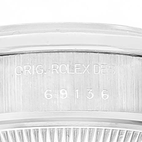 This image shows an engraving on the bezel of a Rolex President 69136 Women's Platinum Silver Dial 69136 Women's Platinum Silver Dial model watch.
