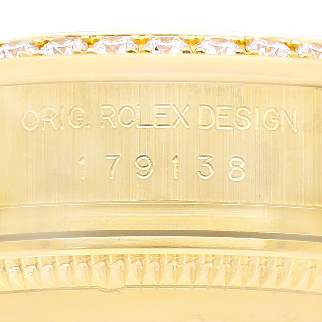 The image shows a detailed side view of the Rolex President 179138 Women's Yellow Gold Silver Dial model's case with engraved design numbers.