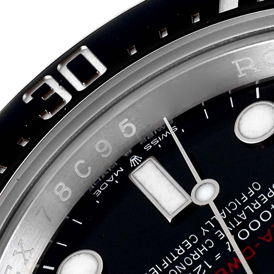 This close-up image of the Rolex Sea-Dweller 126600 Men's Stainless Steel Black Dial 126600 Men's Stainless Steel Black Dial shows the bezel, part of the dial, and a segment of the hands.