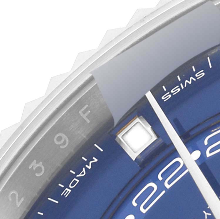 This image shows a close-up of the dial and bezel of the Rolex Sky-Dweller 326934 Men's Stainless Steel Blue Dial 326934 Men's Stainless Steel Blue Dial watch, highlighting the date and part of the 24-hour disc.