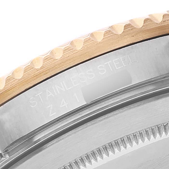 This is a close-up of the stainless steel and gold bezel of a Rolex Submariner 16613 Men's Steel and Gold (two tone) Blue Dial 16613 Men's Steel and Gold (two tone) Blue Dial watch with the model number partially visible.