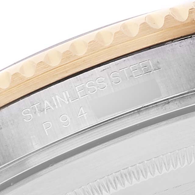 This image shows a close-up of the engraved stainless steel and bezel of a Rolex Submariner 16613 Men's Steel and Gold (two tone) Blue Dial 16613 Men's Steel and Gold (two tone) Blue Dial watch.
