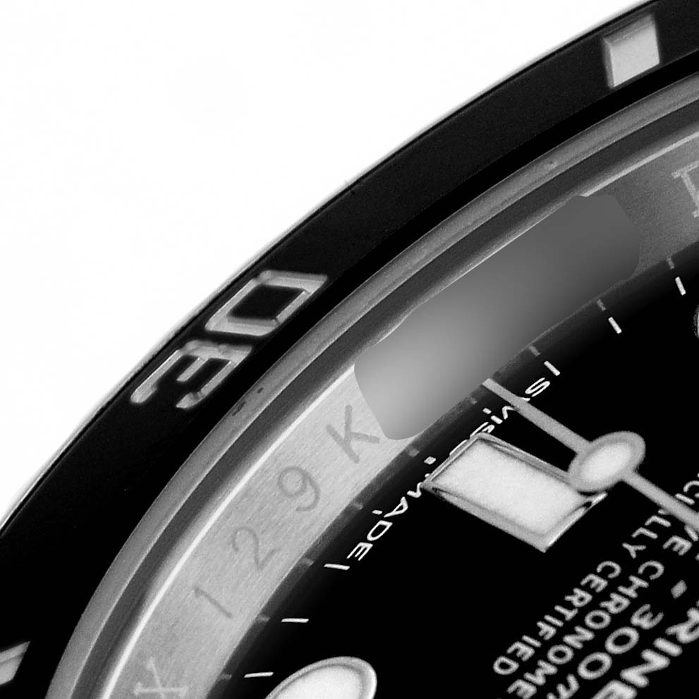 The image shows a close-up of the bezel and dial of a Rolex Submariner 114060 Men's Stainless Steel Black Dial, highlighting the minute markers and luminous details.