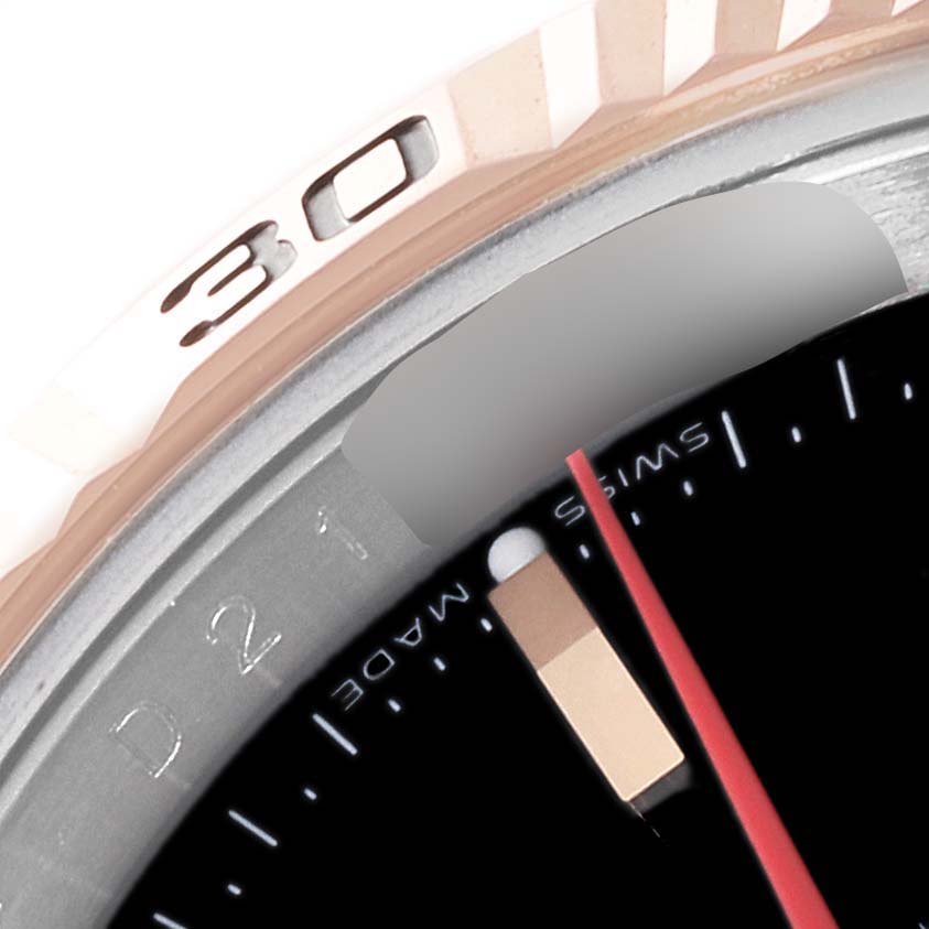This image shows a close-up of the Rolex Turn-o-Graph 116261 Men
s Steel and Gold (two tone) Black Dial 116261 Men
s Steel and Gold (two tone) Black Dial watch, specifically the bezel with the 30-minute mark and part of the dial.