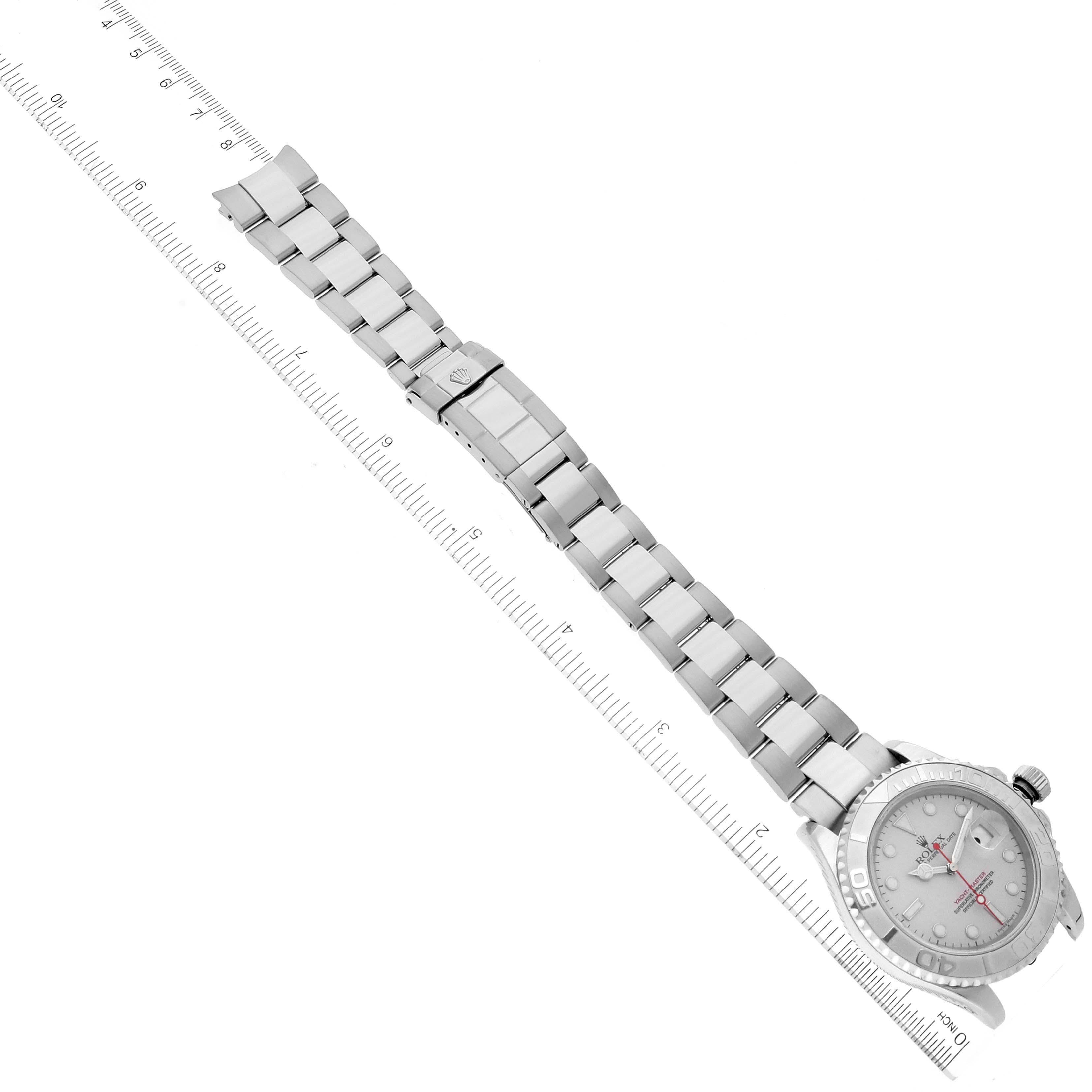 The image shows a top view of a Rolex Yacht-Master 16622 Men's Stainless Steel Silver Dial 16622 Men's Stainless Steel Silver Dial watch, highlighting its bracelet and watch face with a ruler for scale.