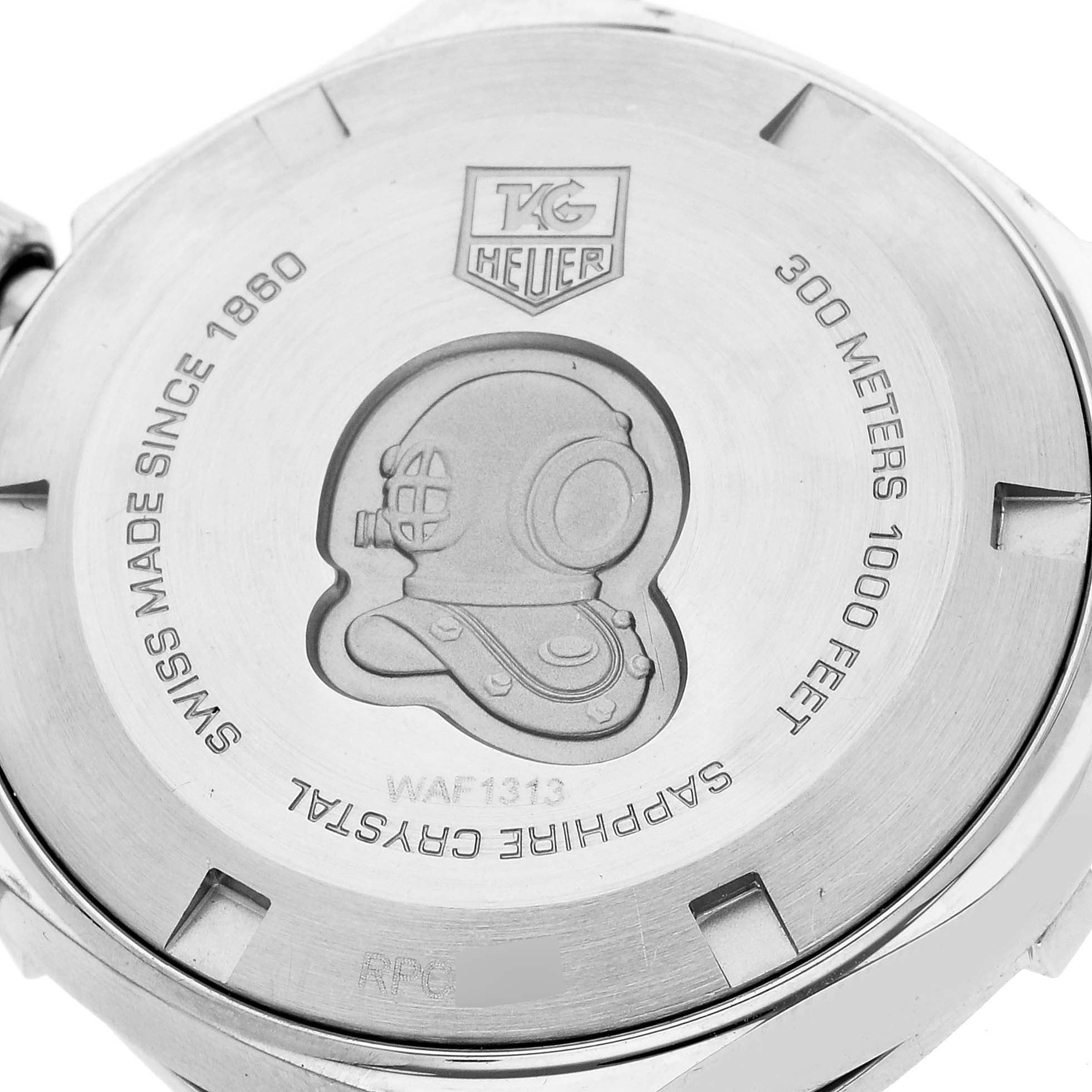 The image shows the back of a Tag Heuer Aquaracer WAF1313.BA0819 Women's Stainless Steel Mother of Pearl Dial WAF1313.BA0819 Women's Stainless Steel Mother of Pearl Dial watch, displaying engravings and the brand logo.