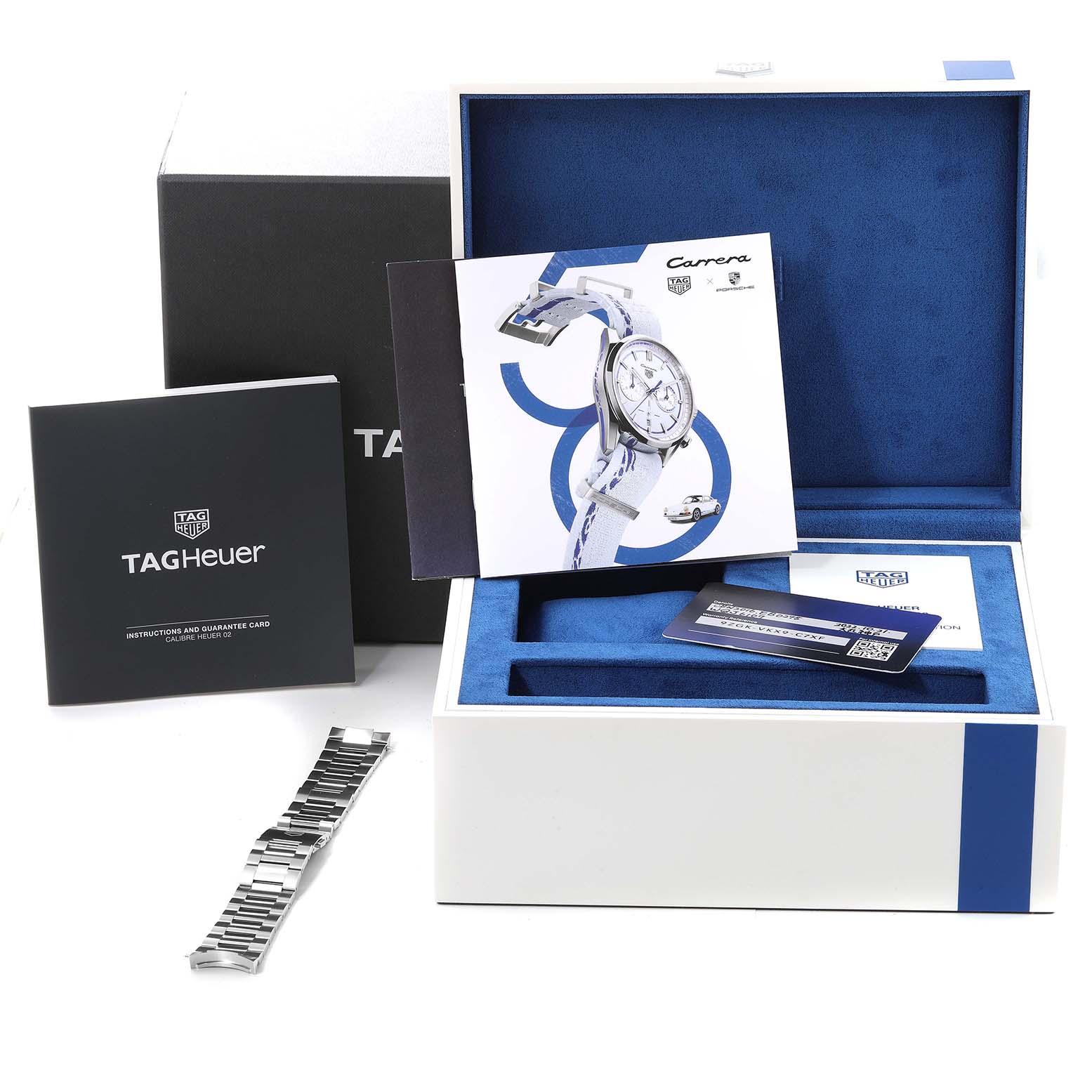 The image shows a Tag Heuer Carrera watch box with manuals, a guarantee card, and a metal bracelet accessory.