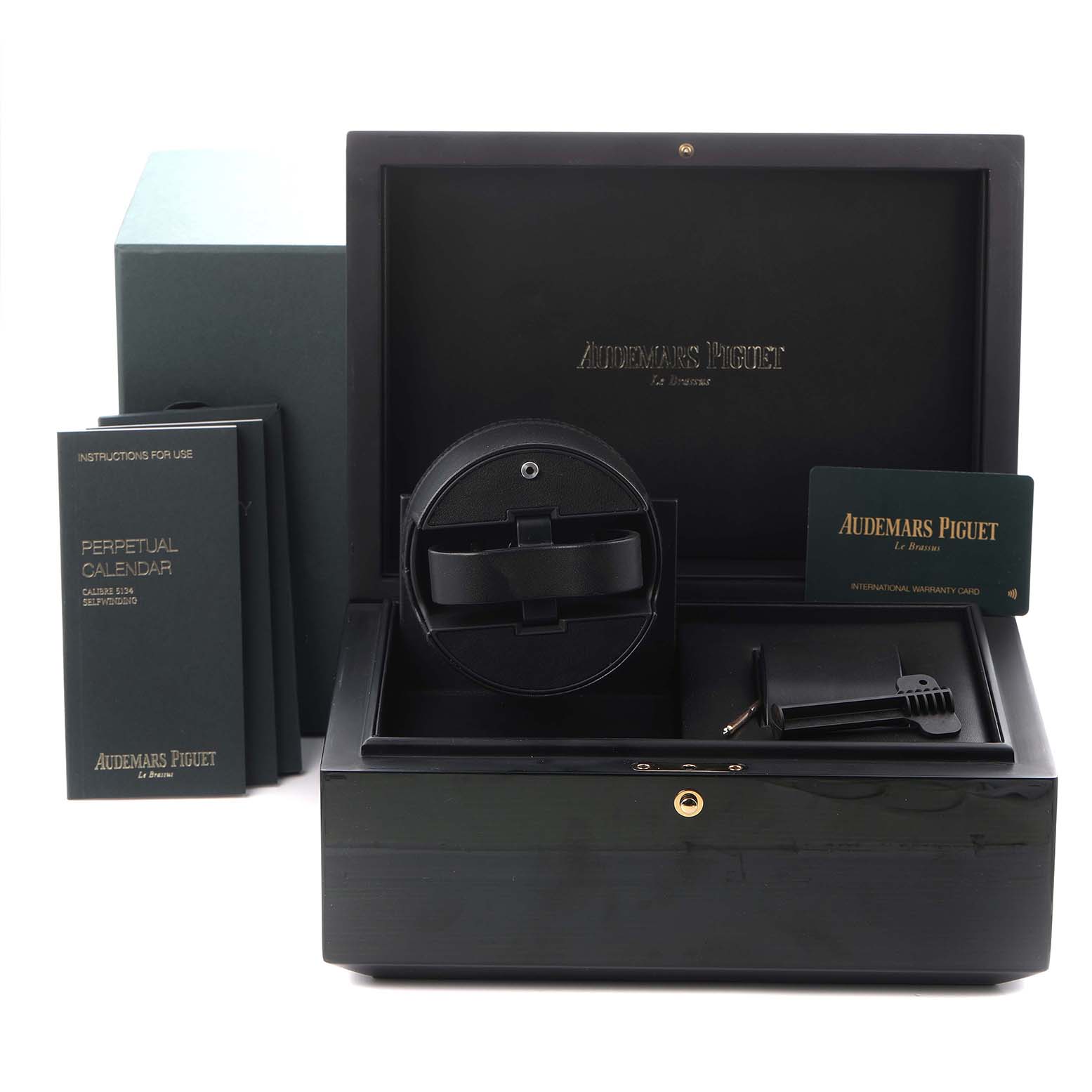 The image shows a display box for the Audemars Piguet Millenary 26394OR.OO.D027KB.01 Men
s Rose Gold Blue Dial 26394OR.OO.D027KB.01 Men
s Rose Gold Blue Dial watch, with manuals, a winder, and an international warranty card.