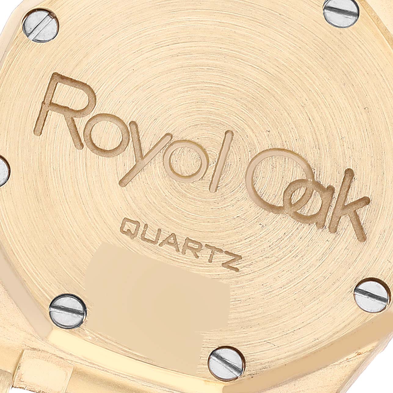 This is a close-up image of the back case of an Audemars Piguet Royal Oak 66270BA Women's Yellow Gold Champagne Dial 66270BA Women's Yellow Gold Champagne Dial watch, showing the engraved model name and quartz movement.