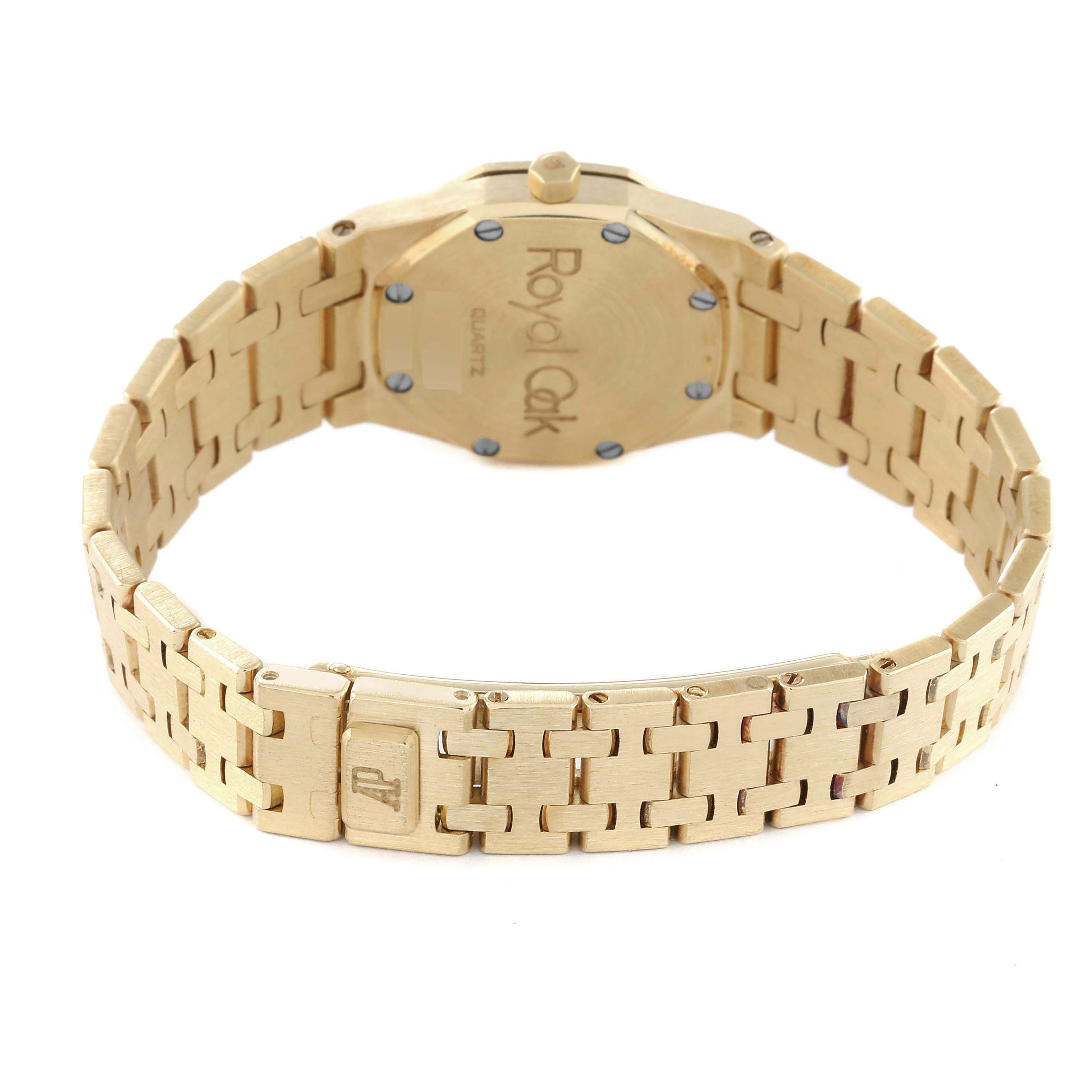 The image shows the back and bracelet of a Royal Oak model by Audemars Piguet in a gold-tone finish.