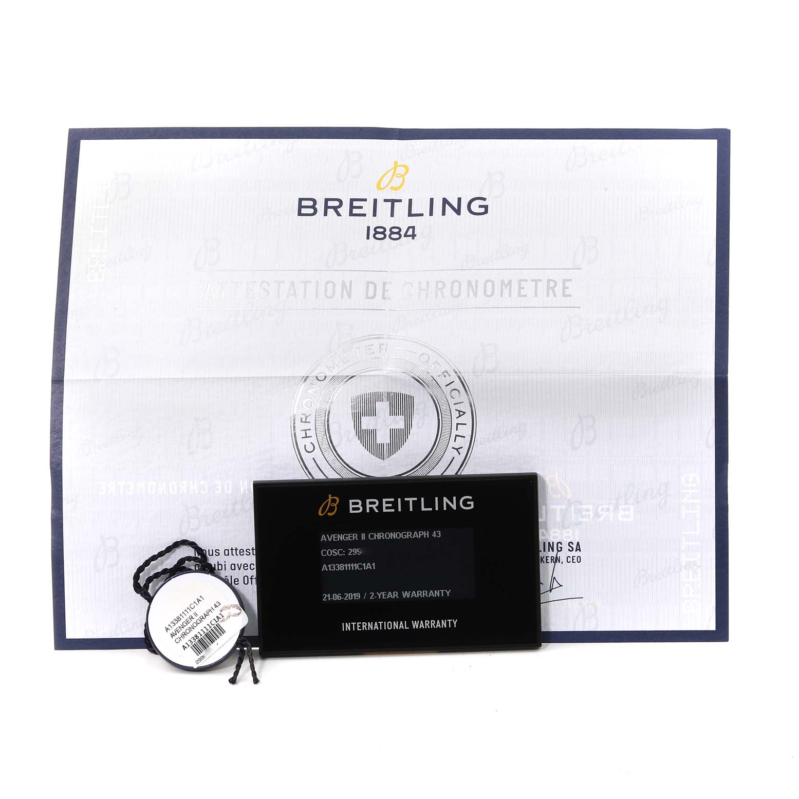 The image shows a Breitling Avenger A13381 Men's Stainless Steel Blue Dial A13381 Men's Stainless Steel Blue Dial II Chronograph's warranty card, tag, and chronometer certificate.