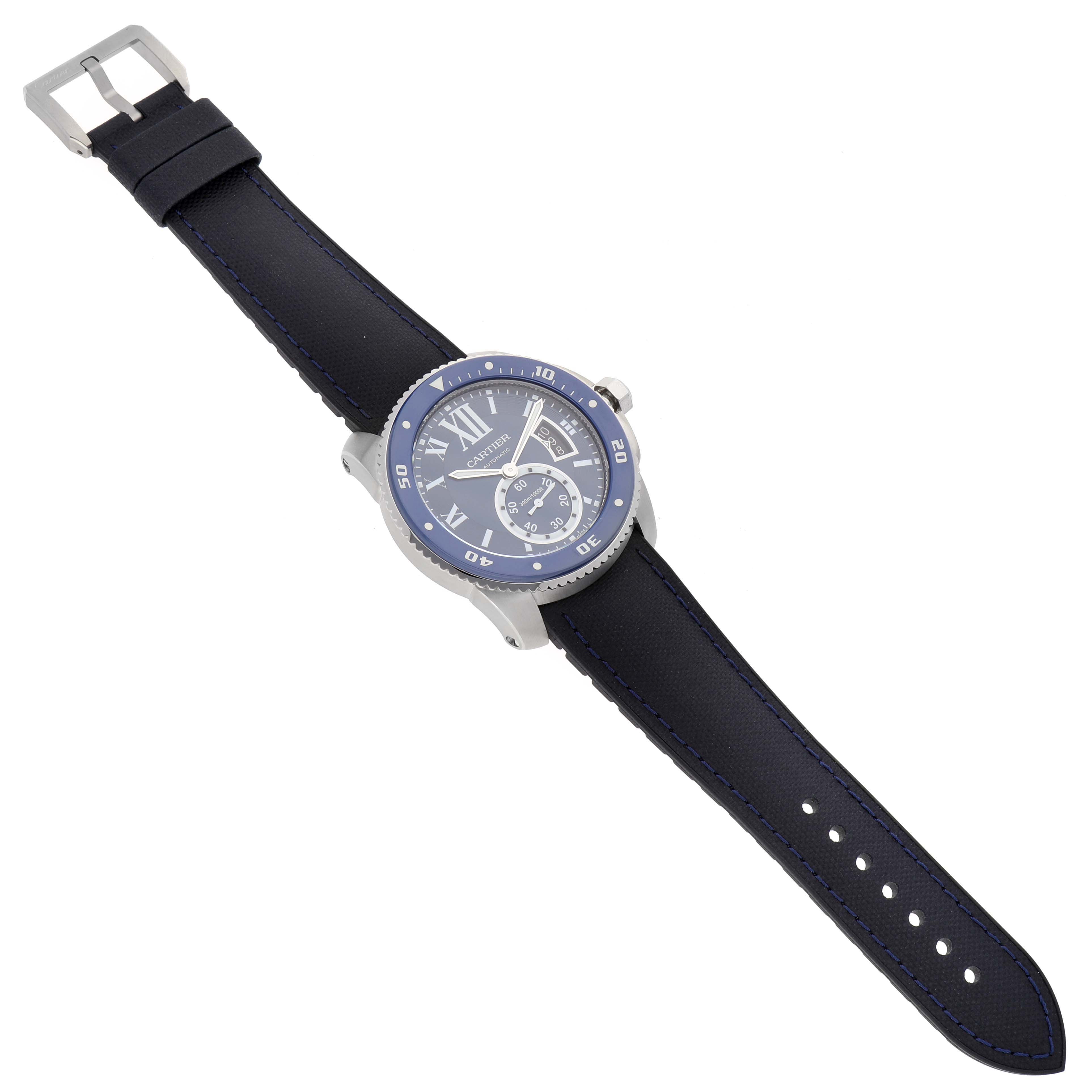 The image shows a Calibre de Cartier watch by Cartier, viewed from the top to display the face, strap, and buckle.