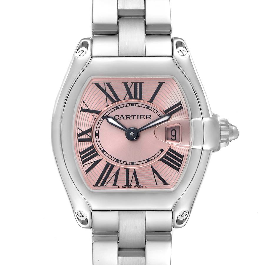 The Cartier Roadster watch is shown from the front, highlighting the pink dial, Roman numerals, and stainless steel bracelet.