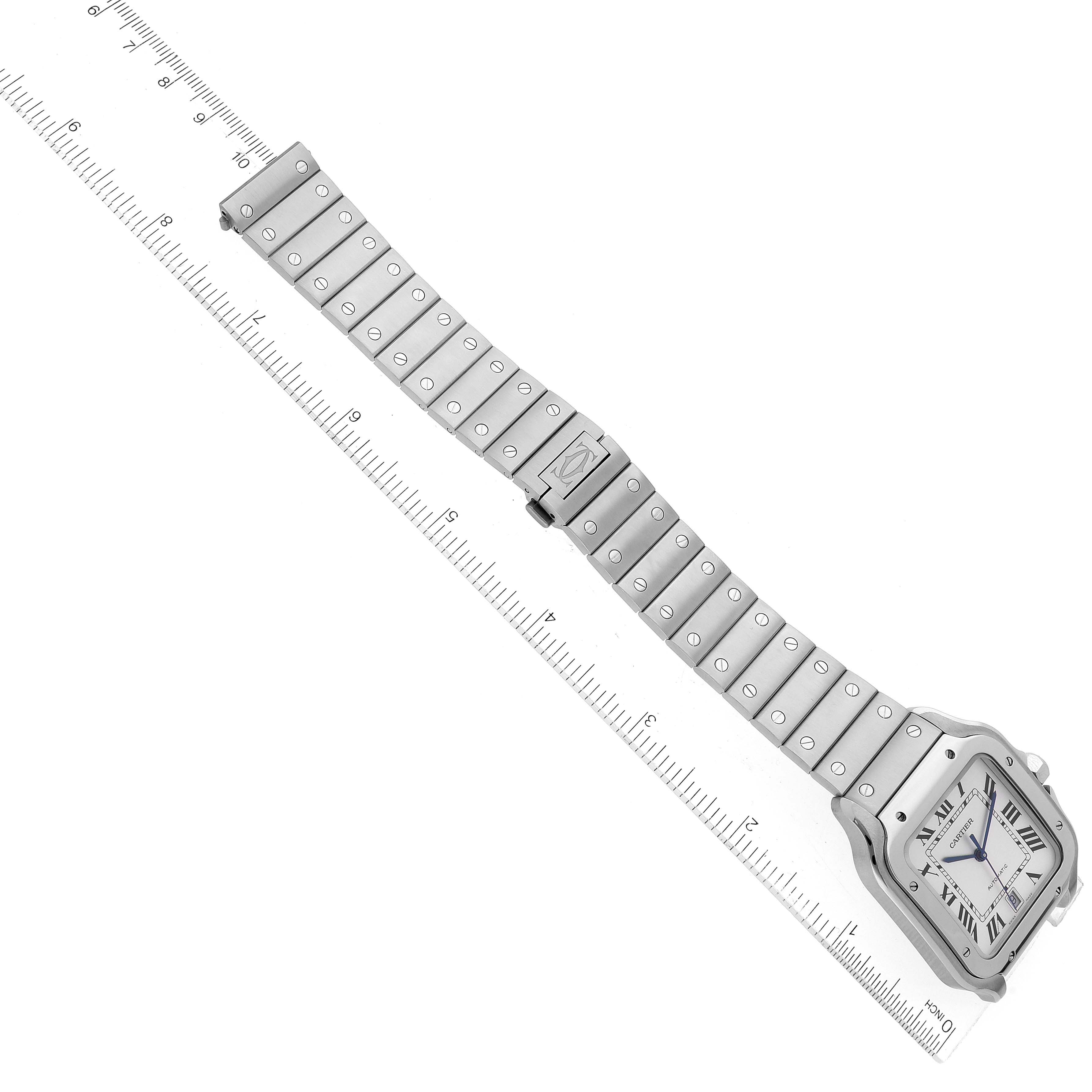 The image shows the top view of the Cartier Santos WSSA0018 Men
s Stainless Steel Silver Dial WSSA0018 Men
s Stainless Steel Silver Dial watch, highlighting its strap and rectangular face with a ruler for scale.