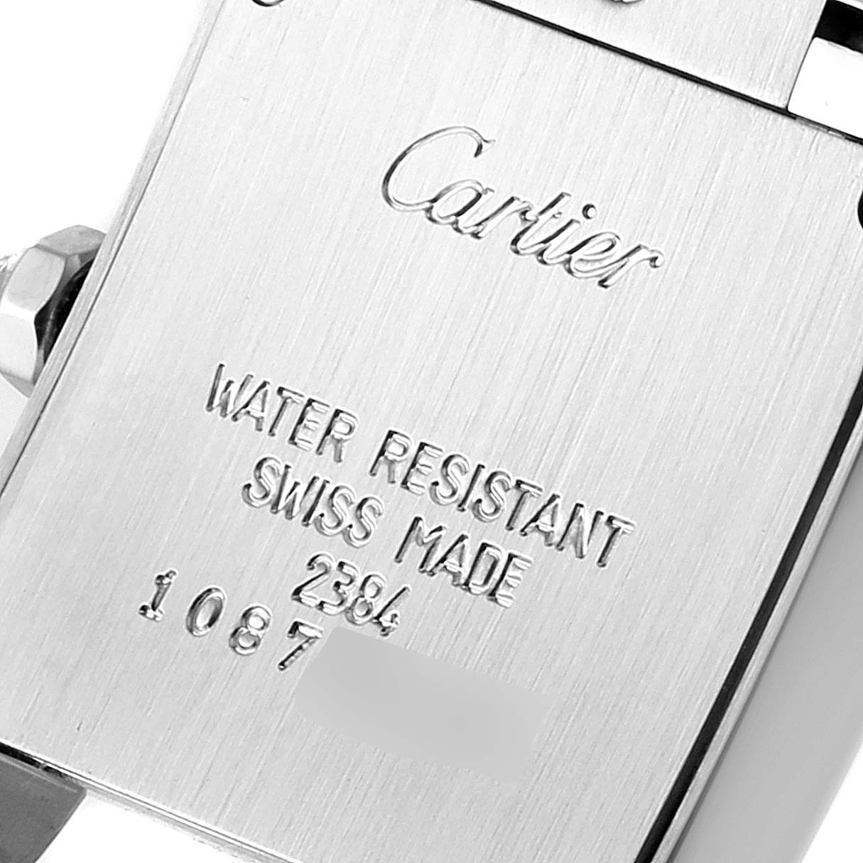 This image shows the engraved case back of a Cartier Tank Francaise W51008Q3 Women's Stainless Steel Silver Dial W51008Q3 Women's Stainless Steel Silver Dial watch, highlighting its water resistance and Swiss origin.