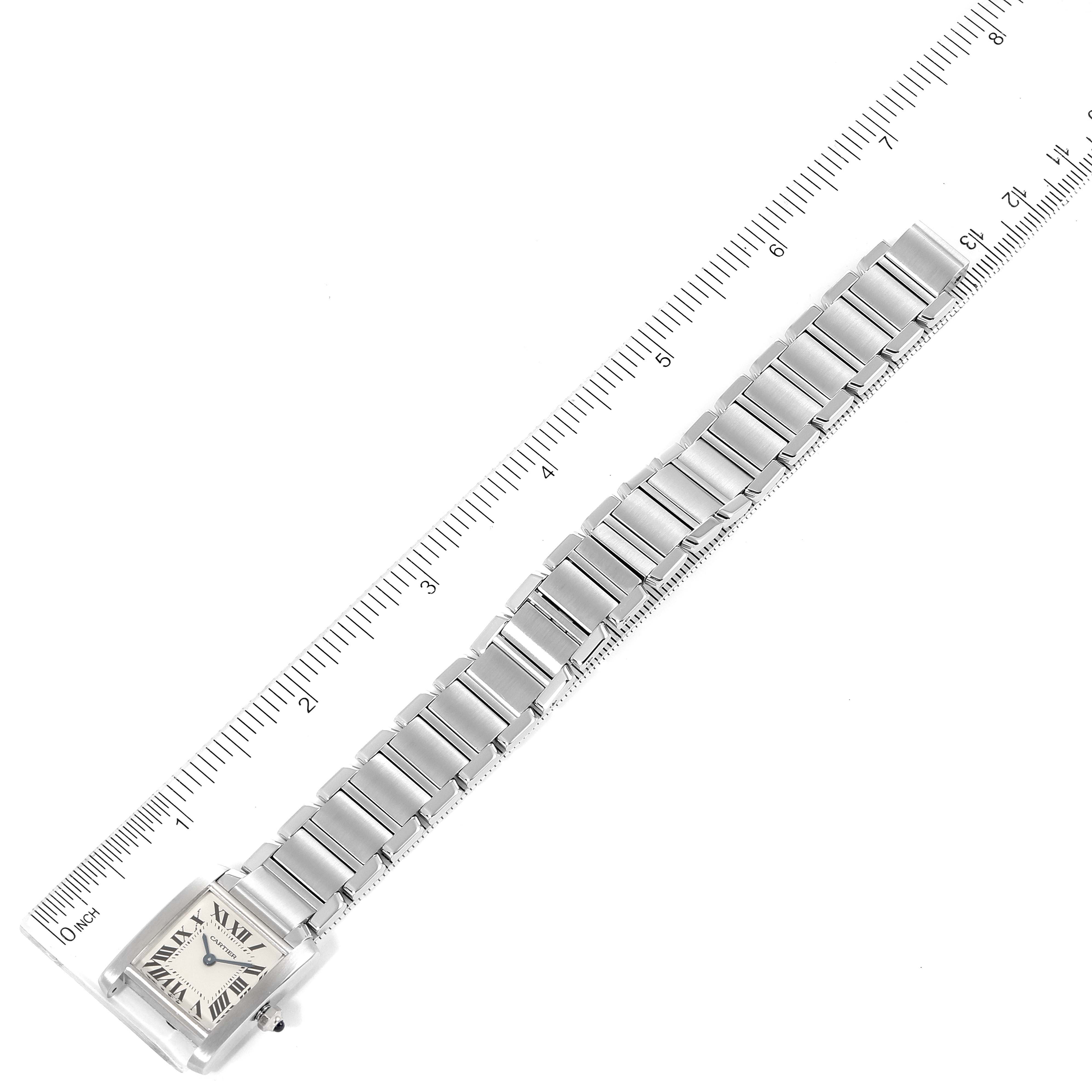 The image shows the Cartier Tank Française watch lying flat alongside a ruler, displaying its face and entire bracelet.