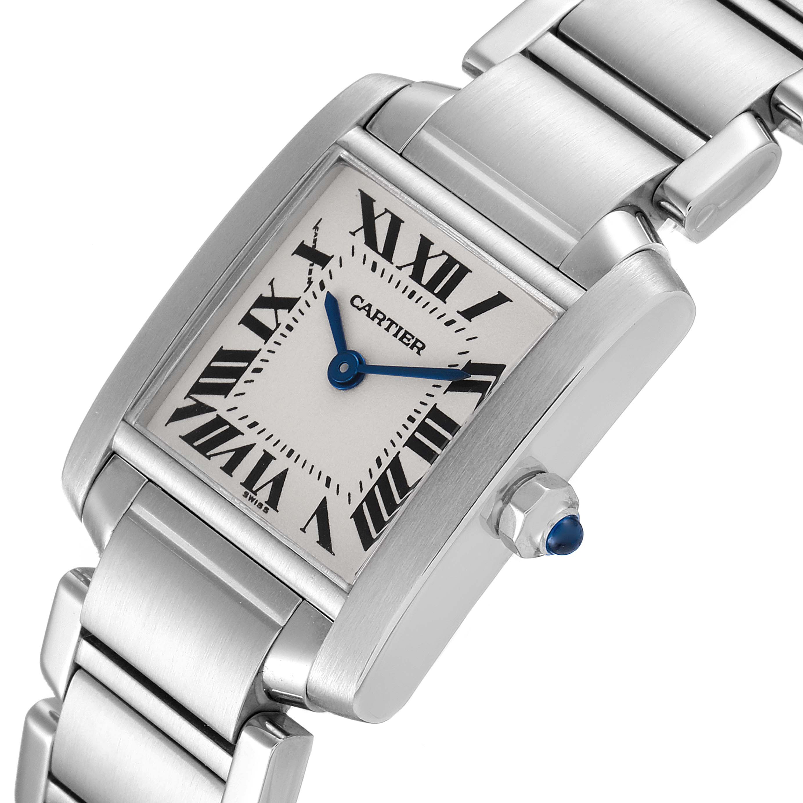 The Cartier Tank Française watch is shown at an angle, highlighting the face, bracelet, and crown with a blue cabochon.
