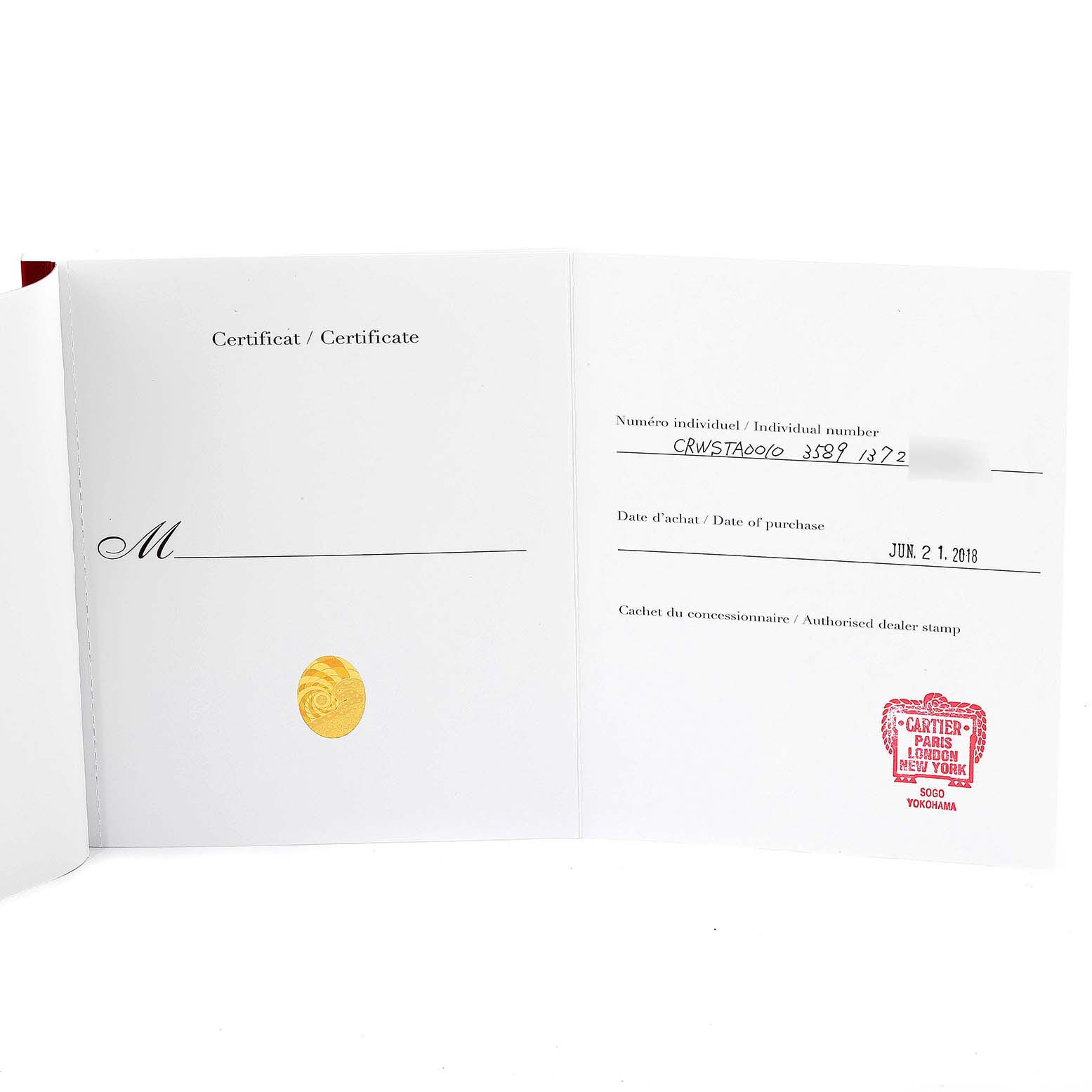 This image shows the open certificate booklet for the Cartier Tank MC WSTA0010 Men's Stainless Steel Blue Dial WSTA0010 Men's Stainless Steel Blue Dial model watch, displaying the individual number and dealer stamp.