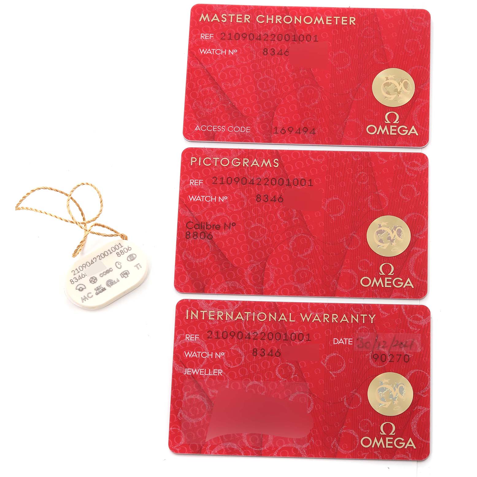 The image shows three red cards (Master Chronometer, Pictograms, and International Warranty) for the Omega Seamaster 210.90.42.20.01.001 Men's Titanium Brown Dial 210.90.42.20.01.001 Men's Titanium Brown Dial watch along with a hangtag.