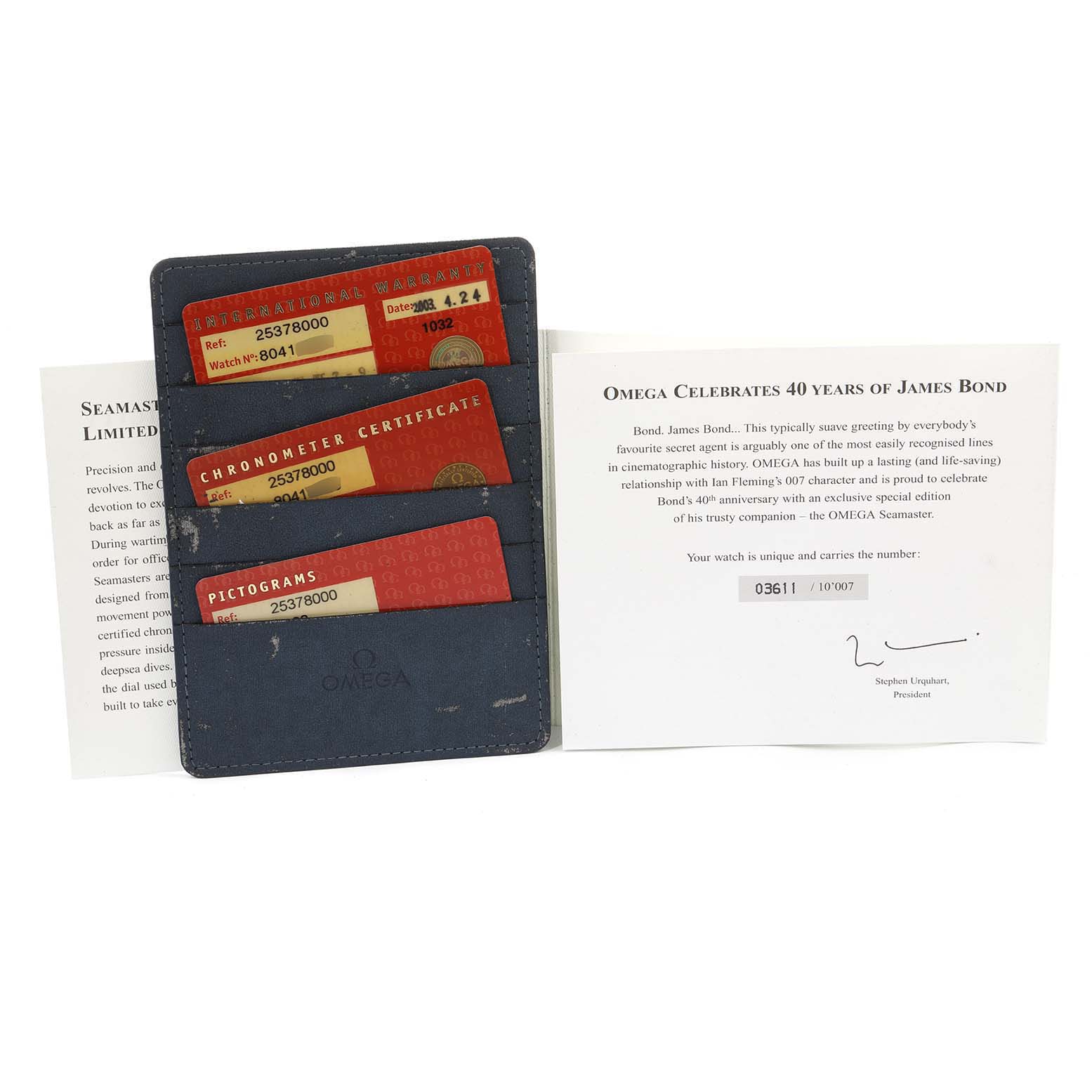 The image shows documentation and cards for the Omega Seamaster 2537.80.00 Men's Stainless Steel Blue Dial 2537.80.00 Men's Stainless Steel Blue Dial model, celebrating 40 years of James Bond.