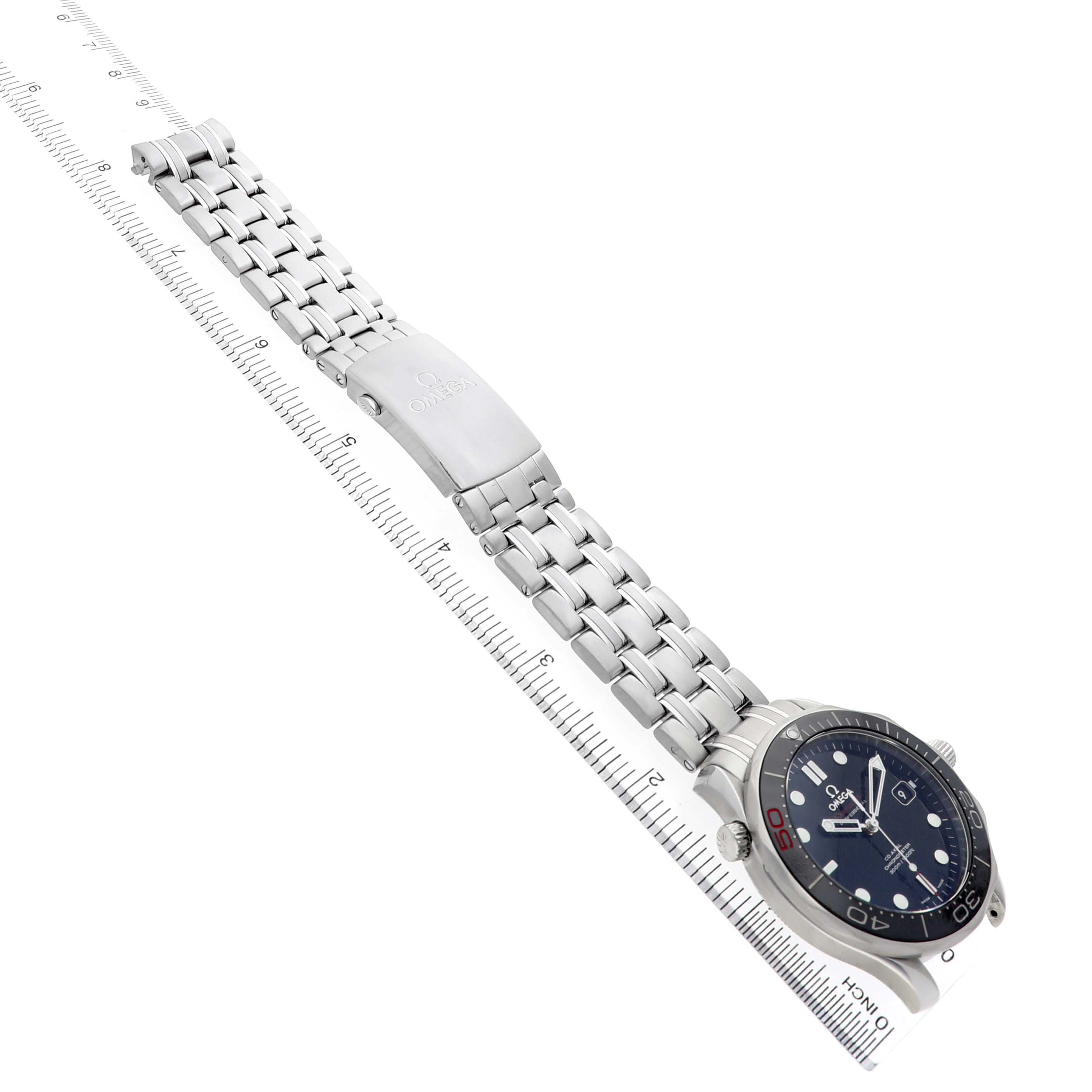 The Omega Seamaster 212.30.41.20.01.005 Men's Stainless Steel Black Dial watch is shown at a diagonal angle, highlighting the bracelet and clasp on a ruler for scale.