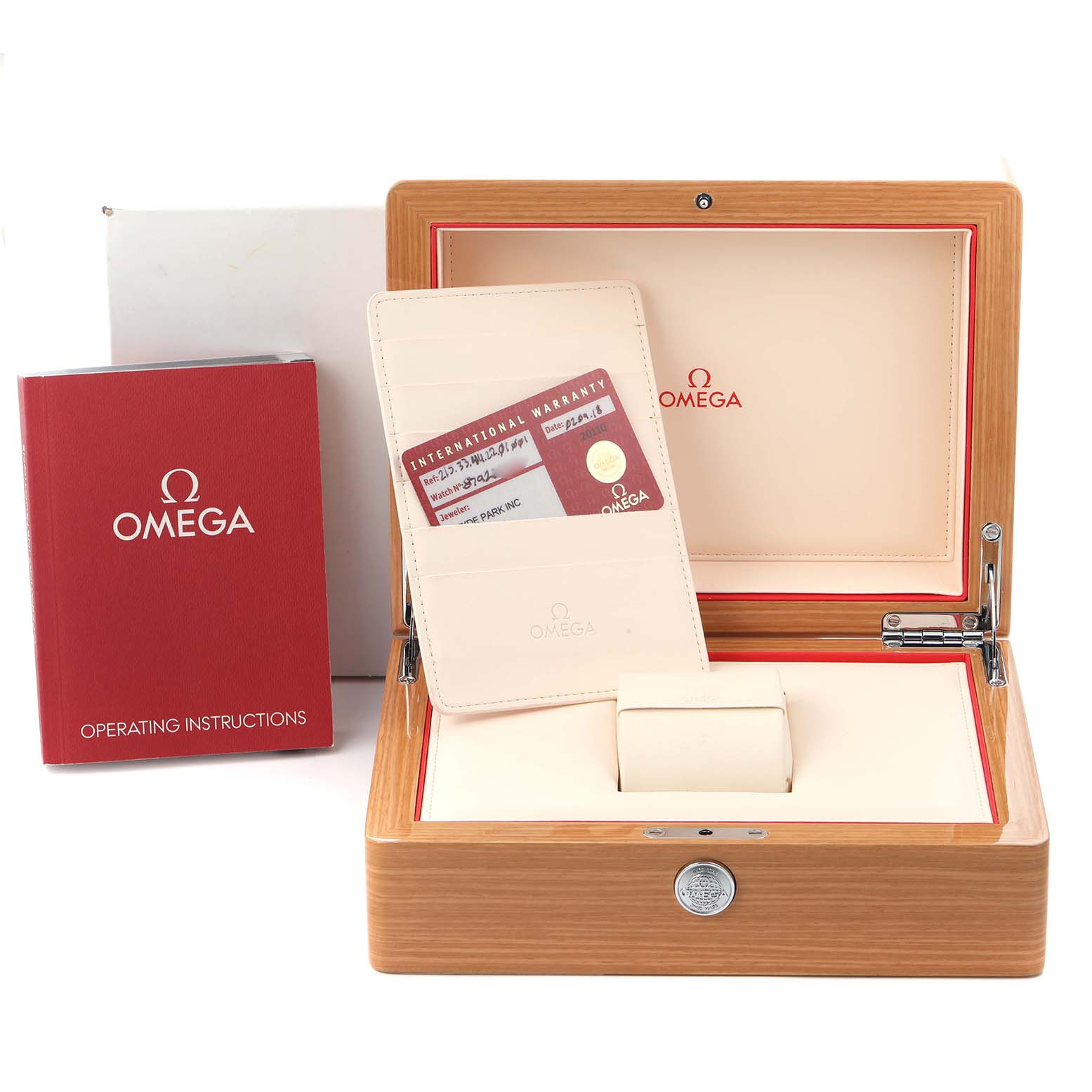 The image shows a wooden Omega Planet Ocean 215.33.44.22.01.001 Men
s Stainless Steel Black Dial 215.33.44.22.01.001 Men
s Stainless Steel Black Dial watch box, warranty card holder, and operating instructions.