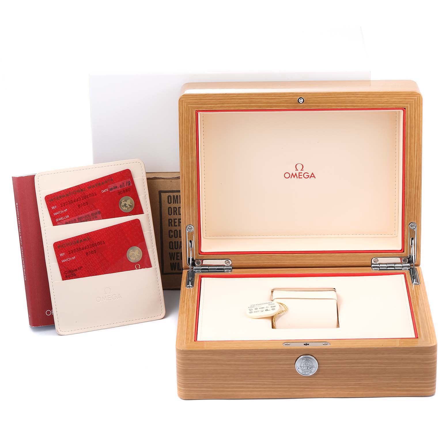 The image shows an open Omega Planet Ocean 232.30.44.22.01.001 Men
s Stainless Steel Black Dial 232.30.44.22.01.001 Men
s Stainless Steel Black Dial watch box with certification cards and a booklet.