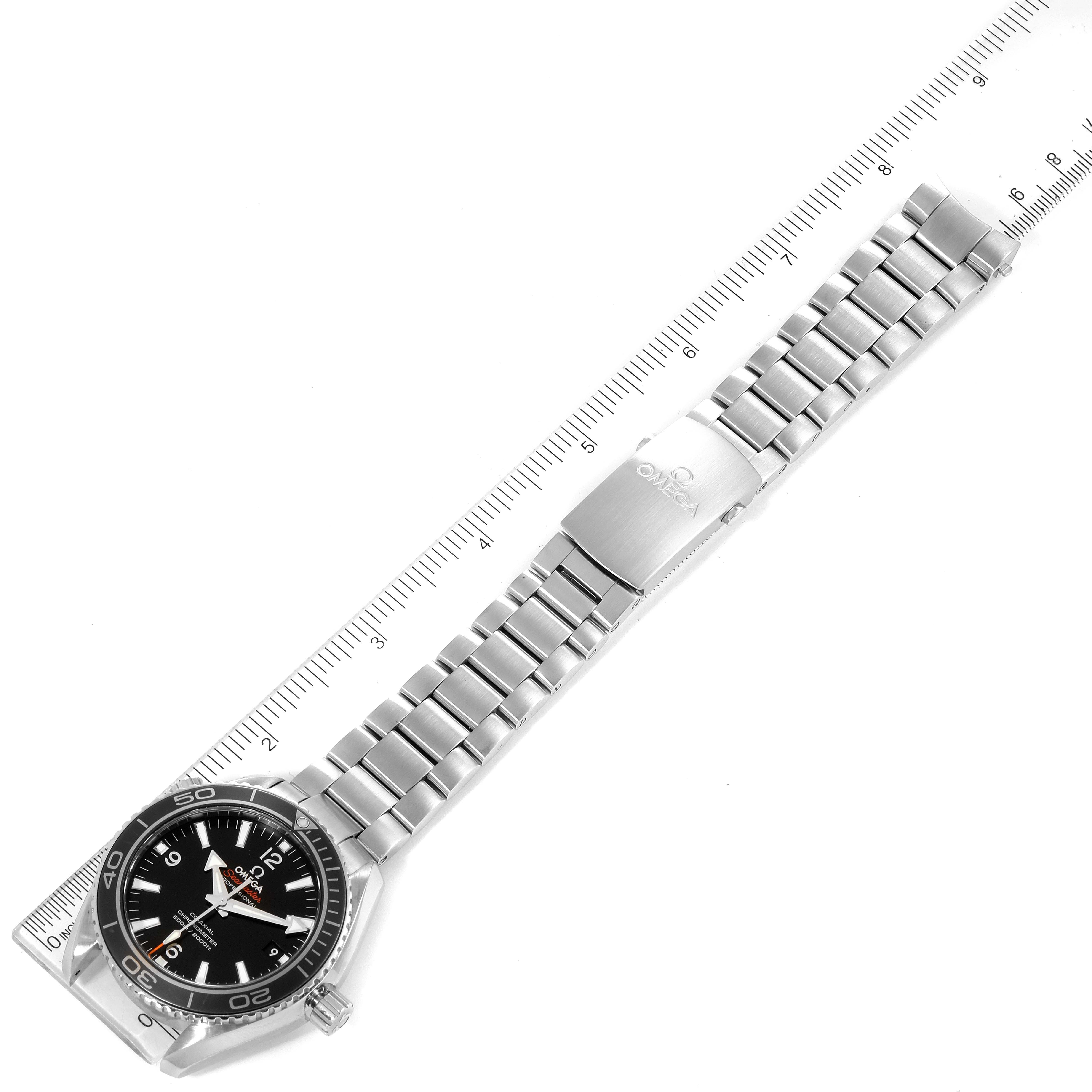 The Omega Planet Ocean 232.30.42.21.01.001 Men's Stainless Steel Black Dial 232.30.42.21.01.001 Men's Stainless Steel Black Dial watch is shown from a top view, displaying the full watch and its metal bracelet along with a ruler for scale.
