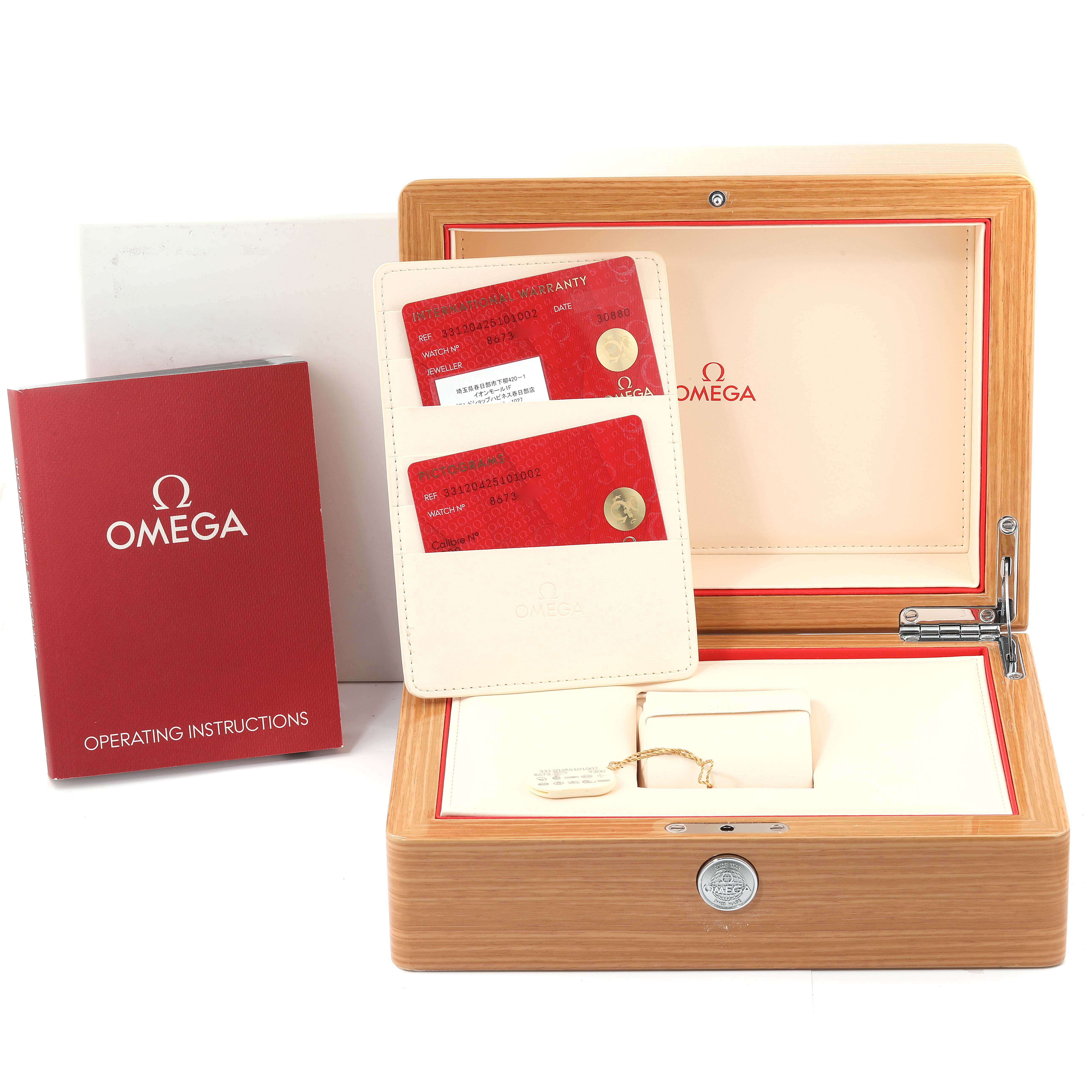 The image shows the packaging of the Omega Speedmaster 331.20.42.51.01.002 Men's Steel and Gold (two tone) Black Dial 331.20.42.51.01.002 Men's Steel and Gold (two tone) Black Dial, including the box, operating instructions, warranty cards, and accessories.