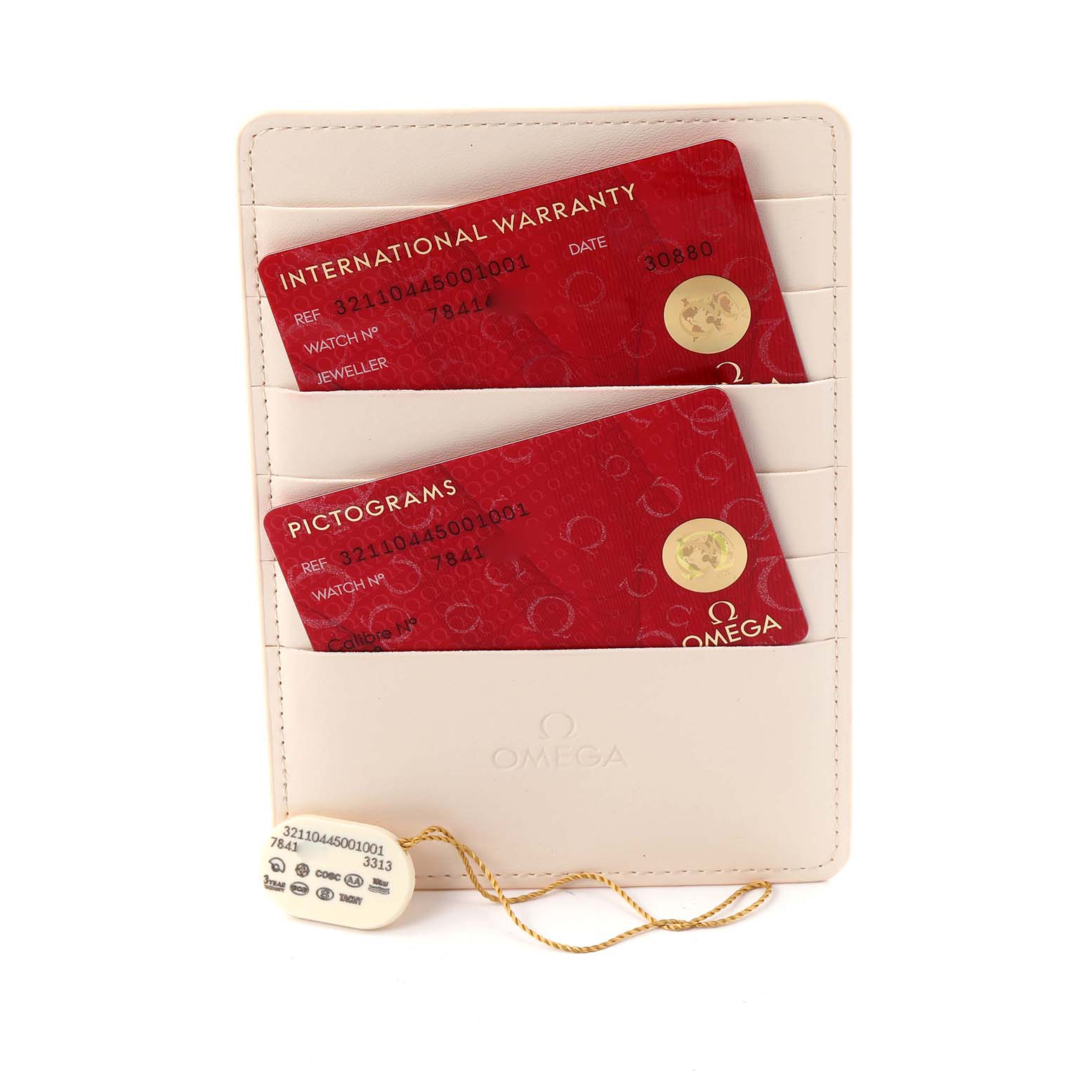 The image shows Omega Speedmaster 321.10.44.50.01.001 Men
s Stainless Steel Black Dial 321.10.44.50.01.001 Men
s Stainless Steel Black Dial accessories, including an international warranty card, a pictograms card, and a tag, all at a top-down angle.