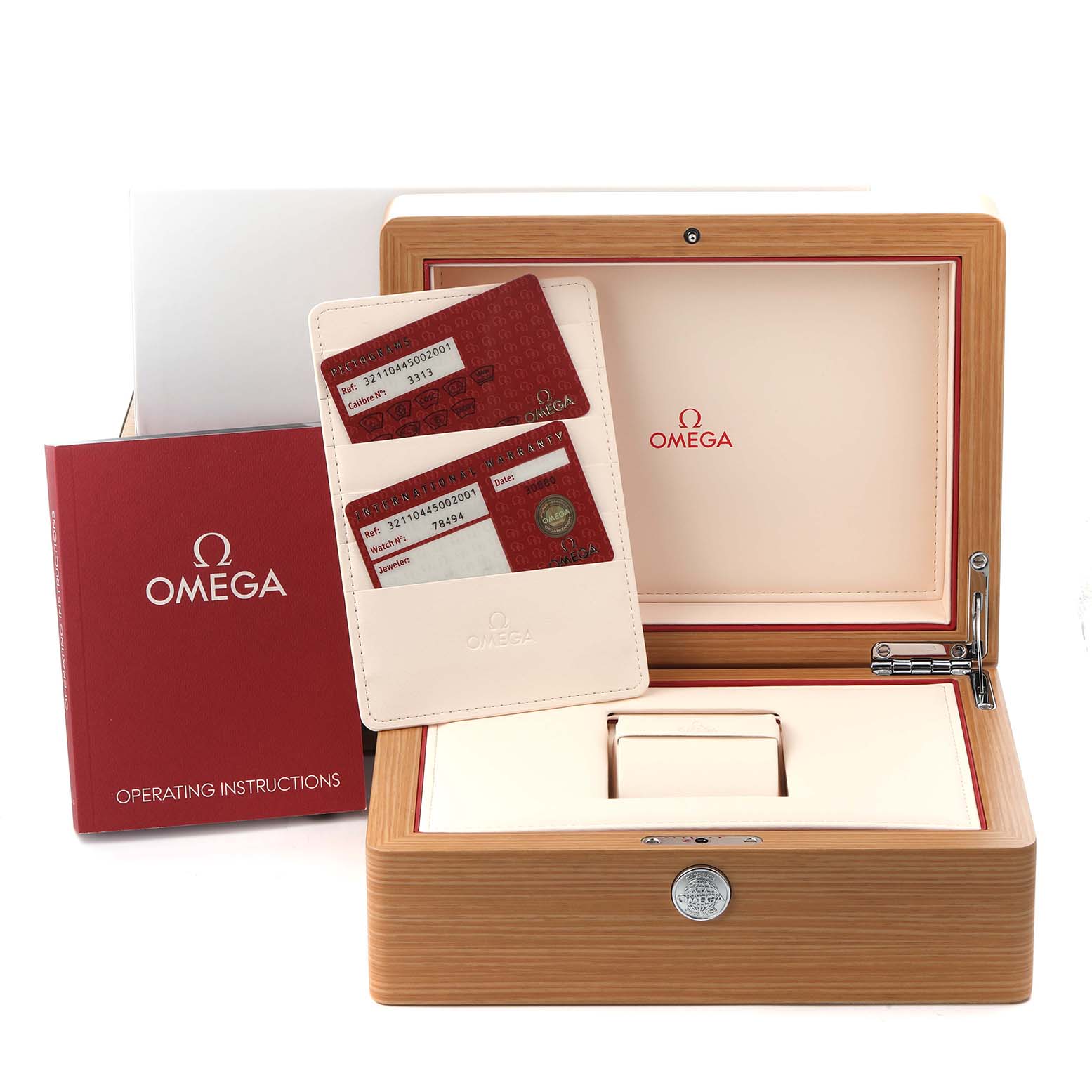 The image shows an Omega Speedmaster 321.10.44.50.02.001 Men
s Stainless Steel Silver Dial 321.10.44.50.02.001 Men
s Stainless Steel Silver Dial watch box, open to display warranty cards and an instruction manual.