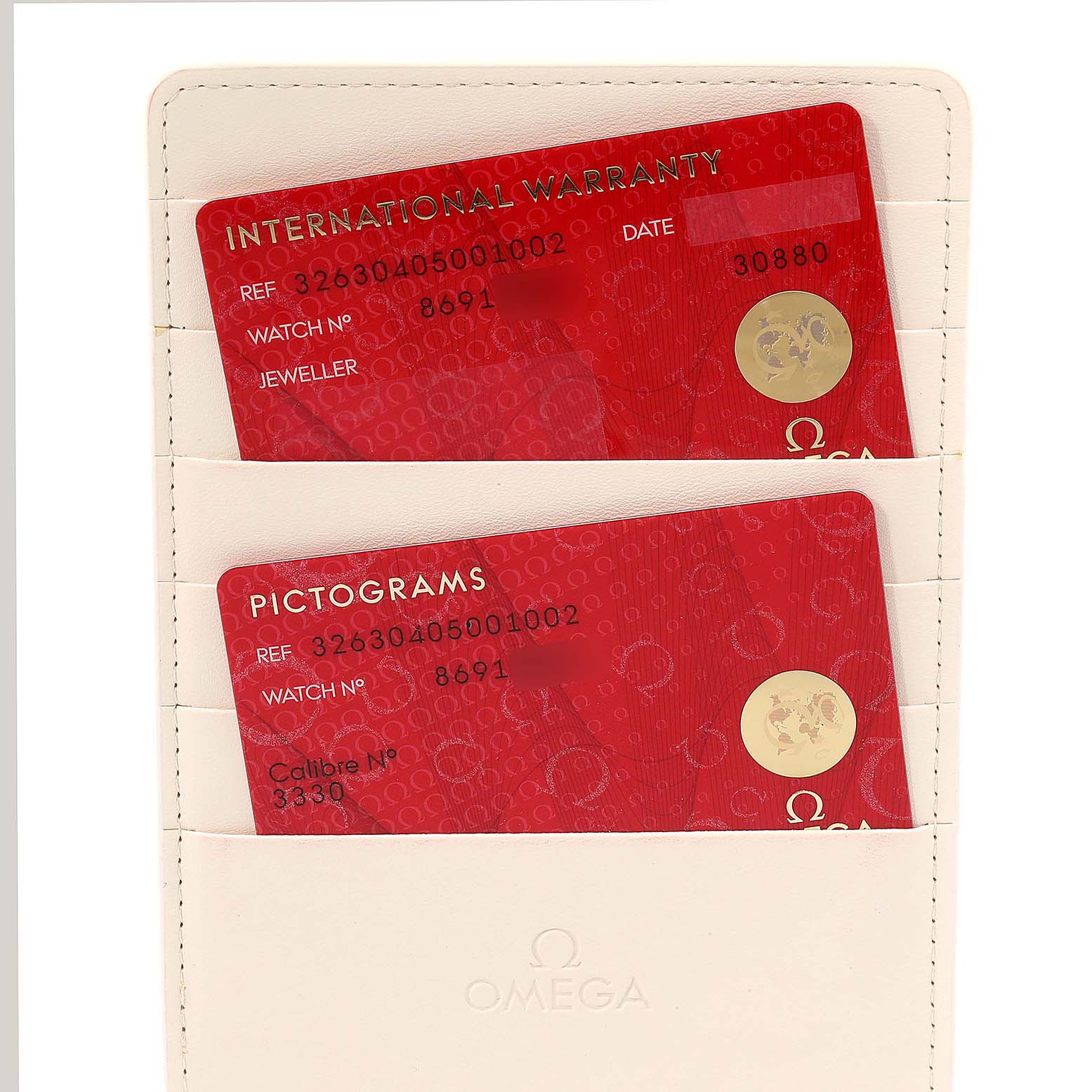 The image shows the International Warranty and Pictograms cards for the Omega Speedmaster 326.30.40.50.01.002 Men
s Stainless Steel Black Dial 326.30.40.50.01.002 Men
s Stainless Steel Black Dial, held in a cream-colored cardholder.