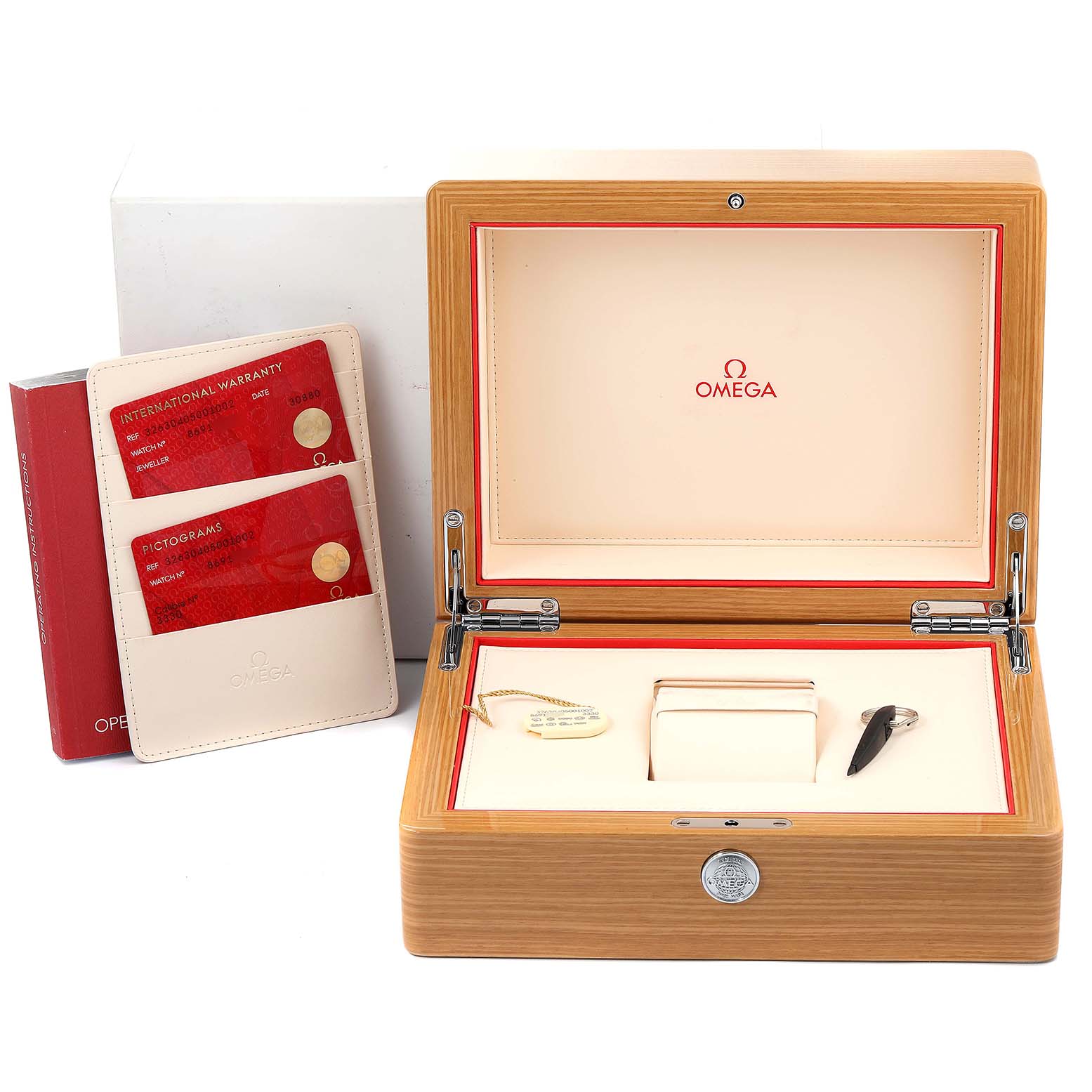 The image shows the accessories and packaging for an Omega Speedmaster 326.30.40.50.01.002 Men
s Stainless Steel Black Dial 326.30.40.50.01.002 Men
s Stainless Steel Black Dial, including the box, warranty card holder, and a manual.