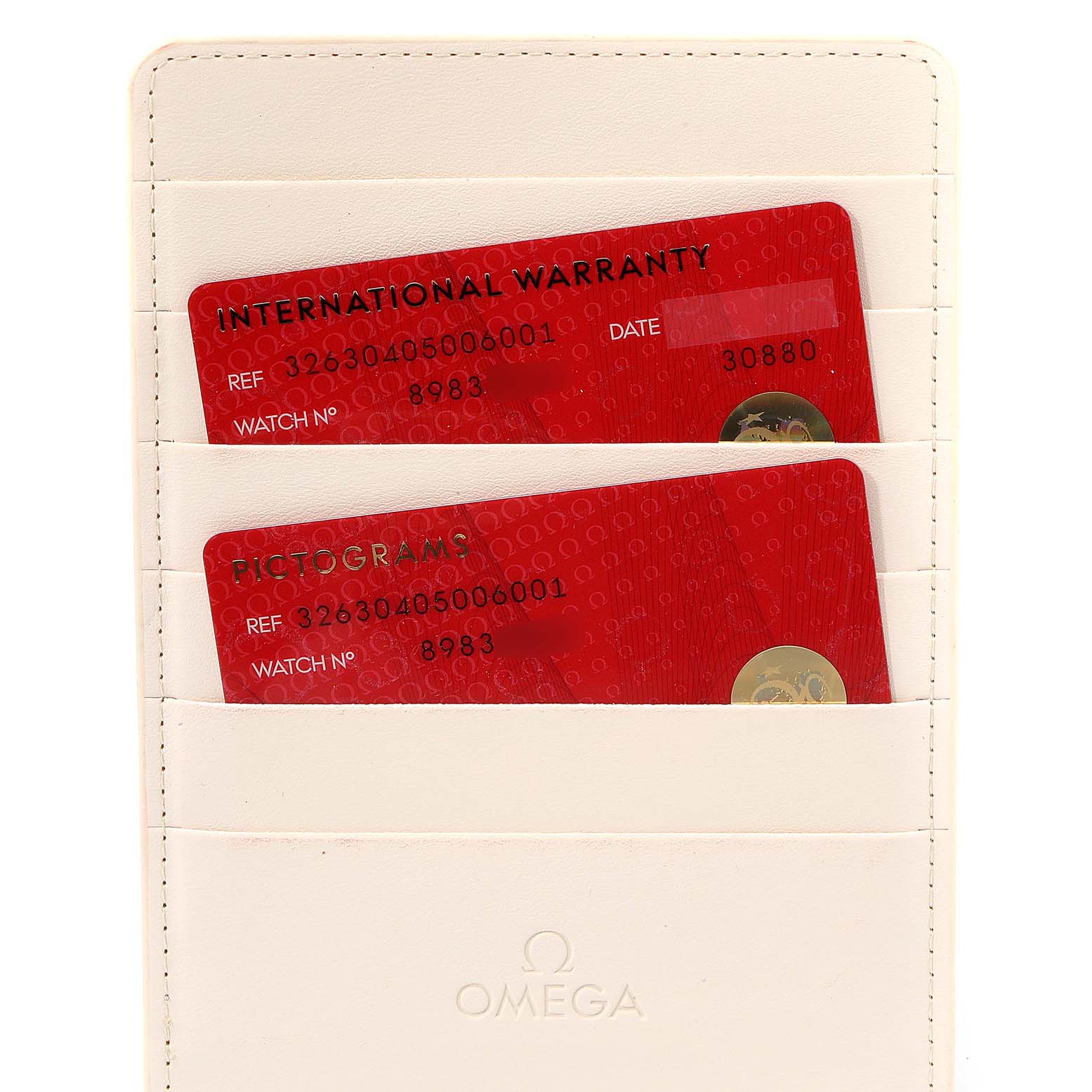 The image shows warranty and pictogram cards for the Omega Speedmaster 326.30.40.50.06.001 Men
s Stainless Steel Grey Dial 326.30.40.50.06.001 Men
s Stainless Steel Grey Dial, placed inside a white cardholder.