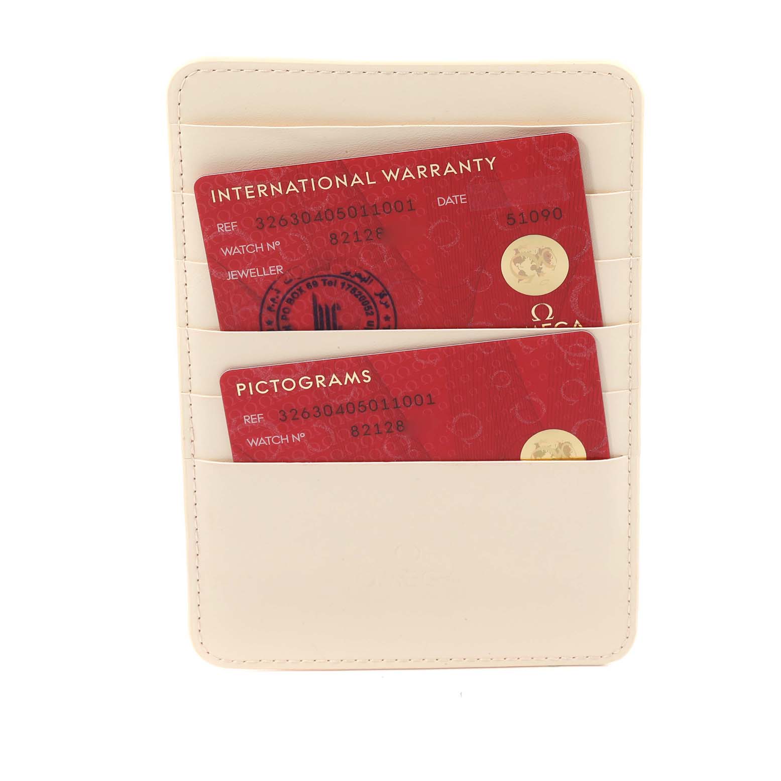 The image shows the warranty and pictograms cards for an Omega Speedmaster 326.30.40.50.11.001 Men
s Stainless Steel Red Dial 326.30.40.50.11.001 Men
s Stainless Steel Red Dial watch tucked in a beige card holder, viewed from the front.
