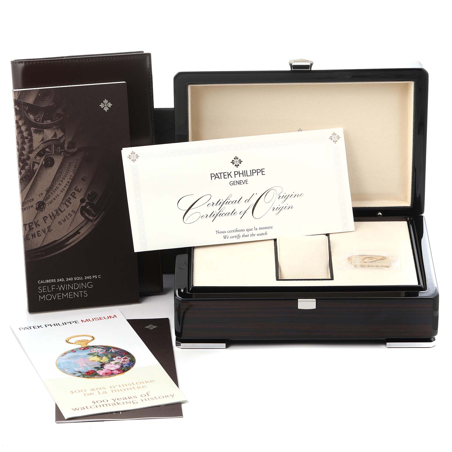 The image shows a Patek Philippe Calatrava 4978/400G-001 Men
s White Gold Silver Dial 4978/400G-001 Men
s White Gold Silver Dial watch box with accessories, including a certificate and booklets, viewed from the front.