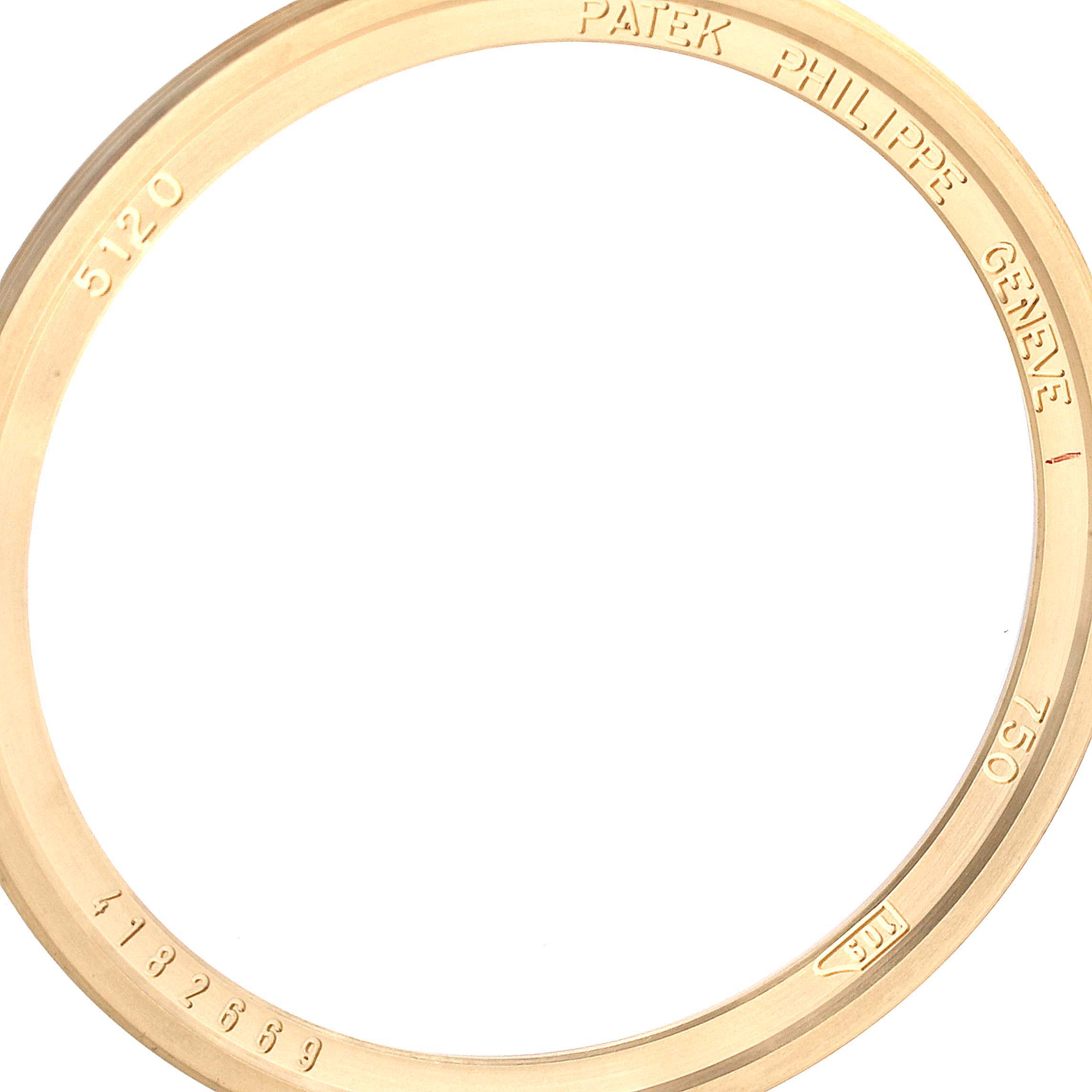 The image shows a close-up of the gold bezel of a Patek Philippe Calatrava 5120J Men's Yellow Gold White Dial 5120J Men's Yellow Gold White Dial model 5120.