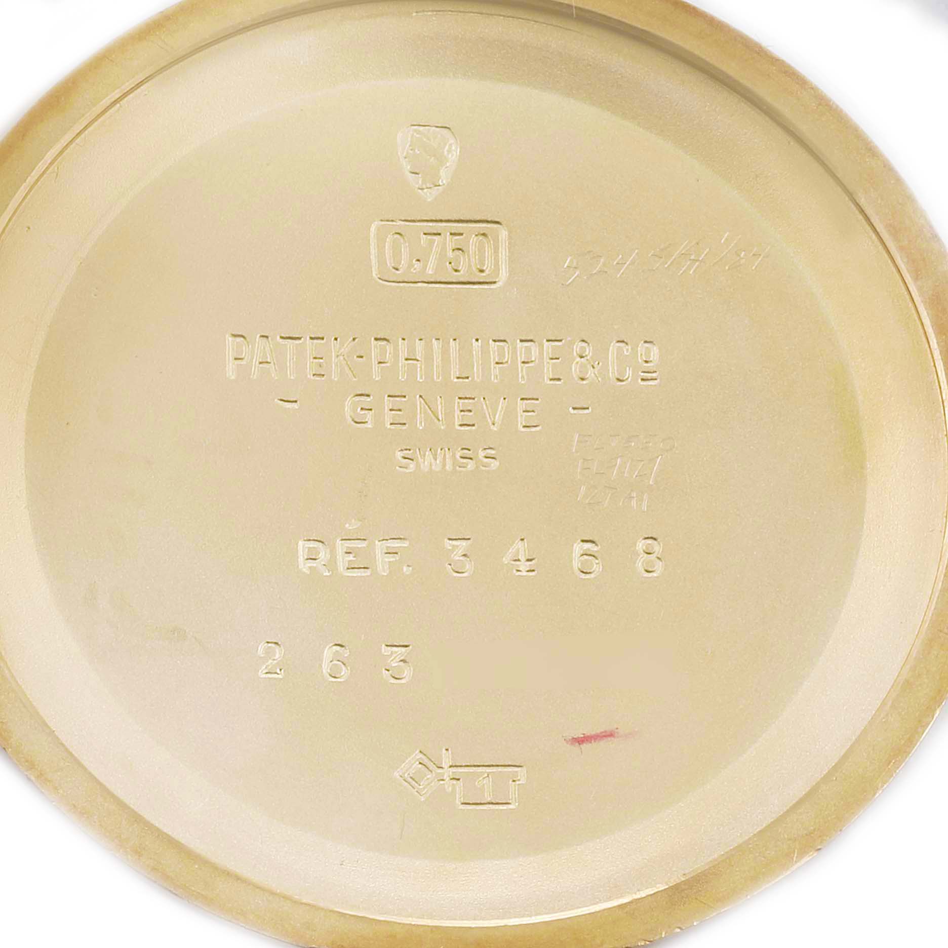 This image shows the interior case back of a Vintage Patek Philippe watch, revealing engravings of the brand, model number, and specifications.