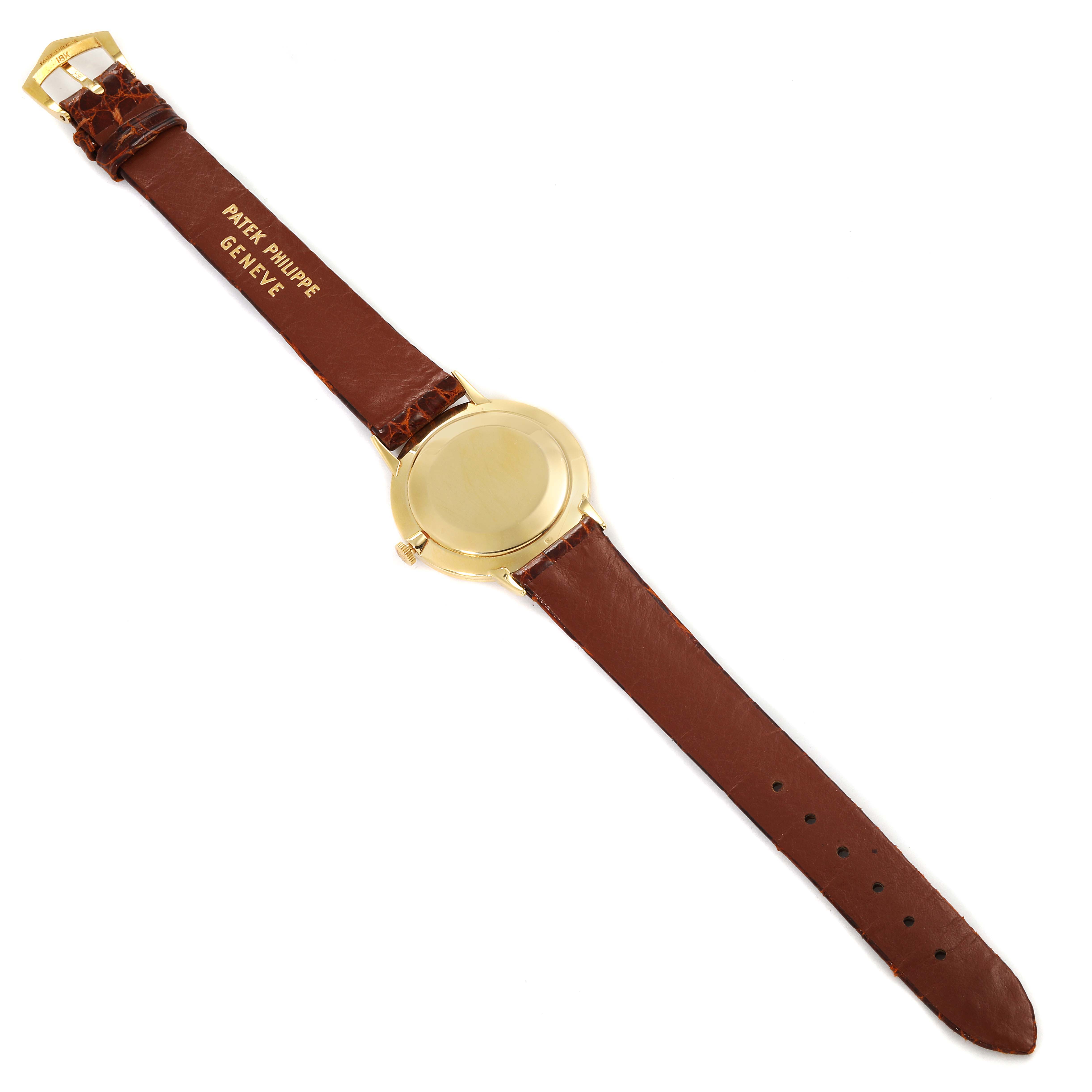 The image shows the back view of a Vintage Patek Philippe watch with a brown leather strap and a gold case.