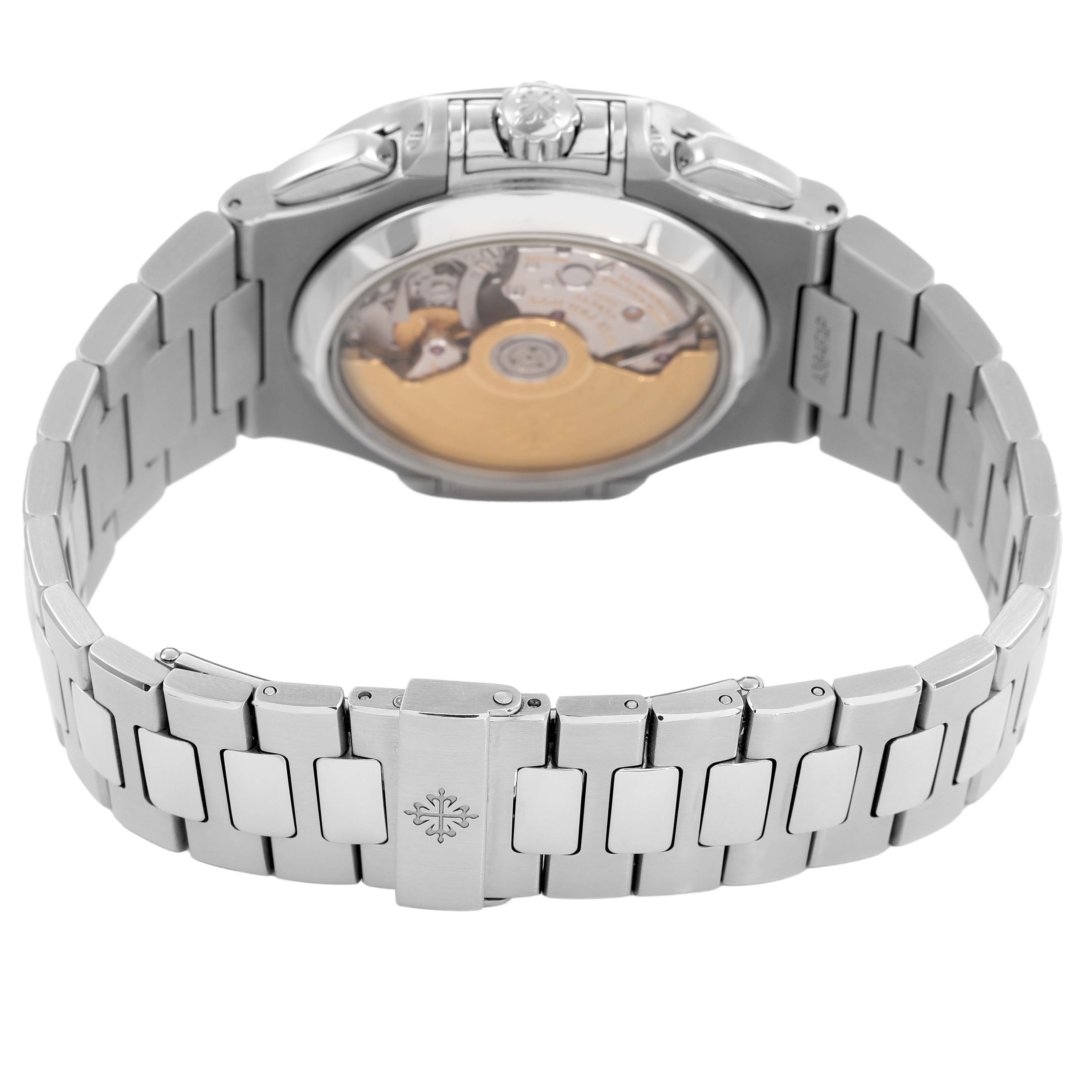 The image shows the back view of a Patek Philippe Nautilus 5980/1A-019 Men's Stainless Steel White Dial watch, focusing on the exposed movement and metal bracelet.