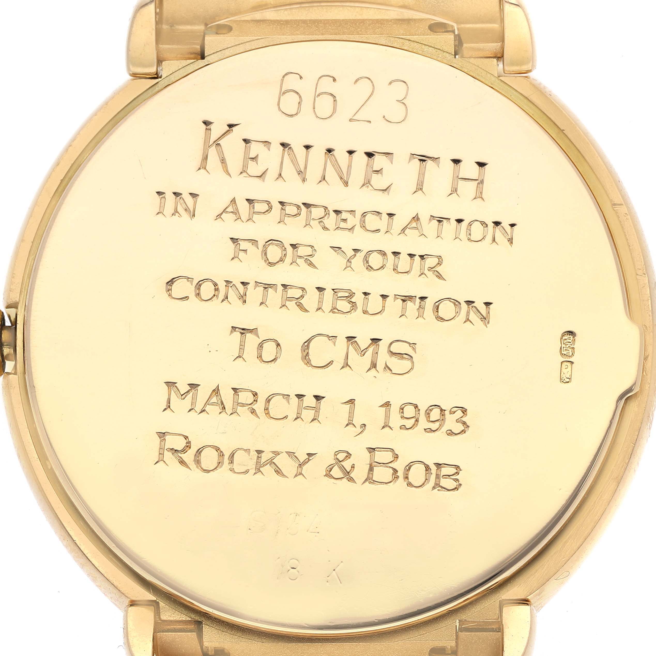 The image shows the back of a Rolex Cellini 6623 Men's Yellow Gold Champagne Dial 6623 Men's Yellow Gold Champagne Dial watch with an engraved message.