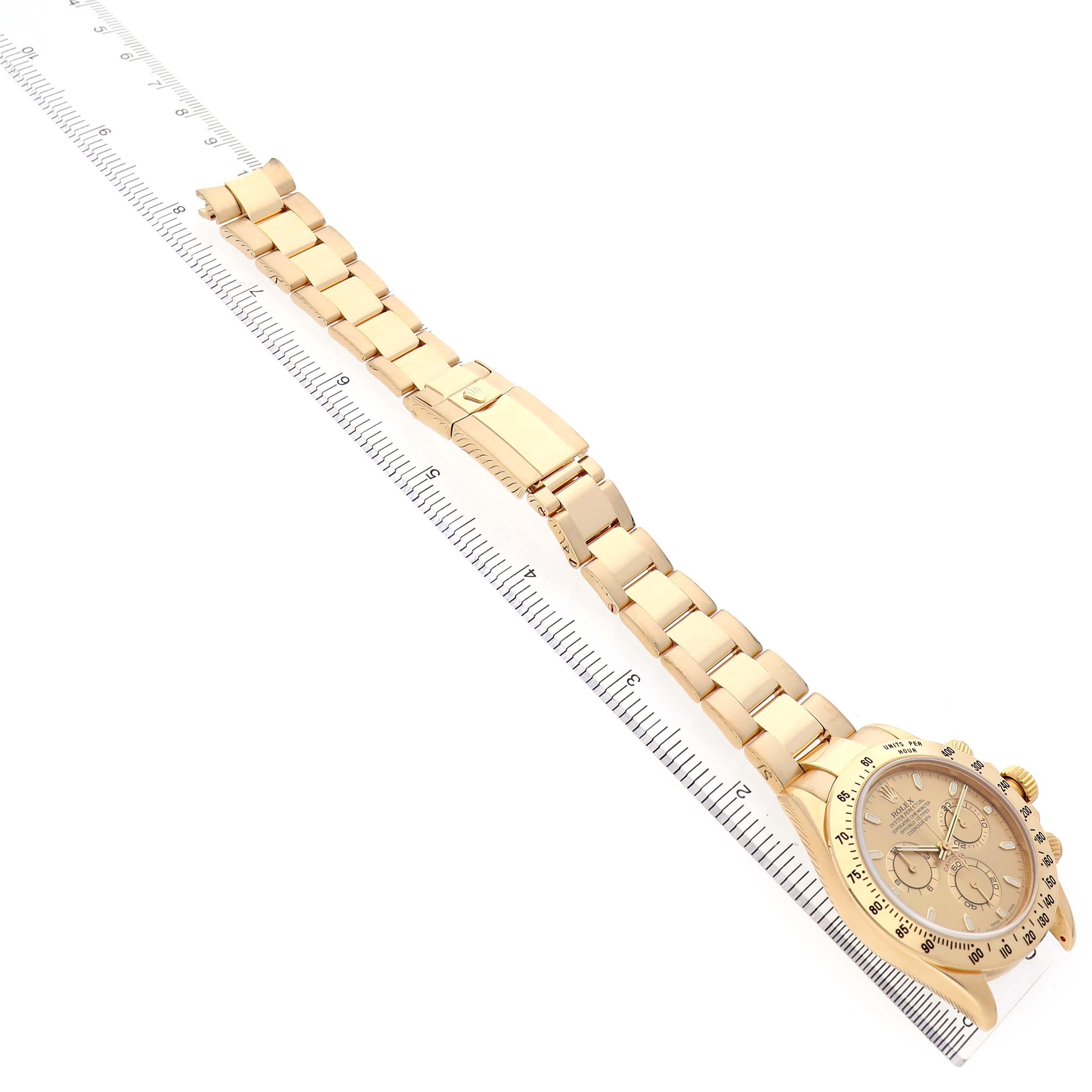 The Rolex Daytona 116528 Men's Yellow Gold Champagne Dial watch is shown from a top-down angle, displaying the full bracelet and dial.