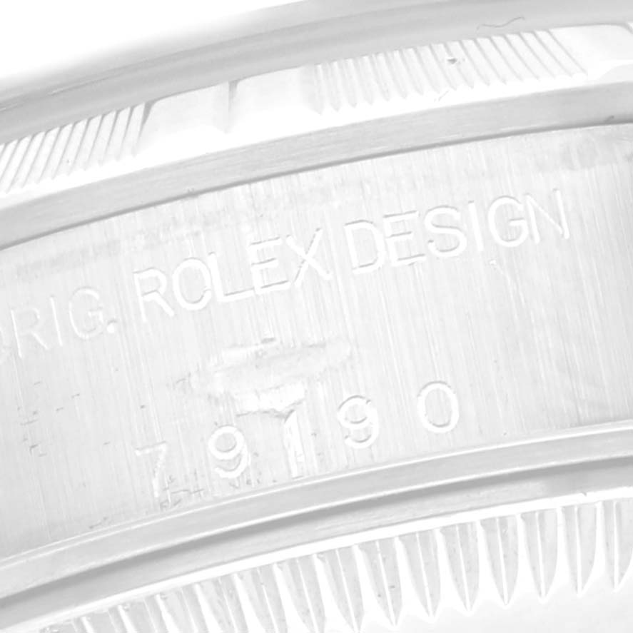 This image shows the engraved side of a Rolex Date 79190 Women
s Stainless Steel Blue Dial 79190 Women
s Stainless Steel Blue Dial model, highlighting the "ROLEX DESIGN" and serial number.