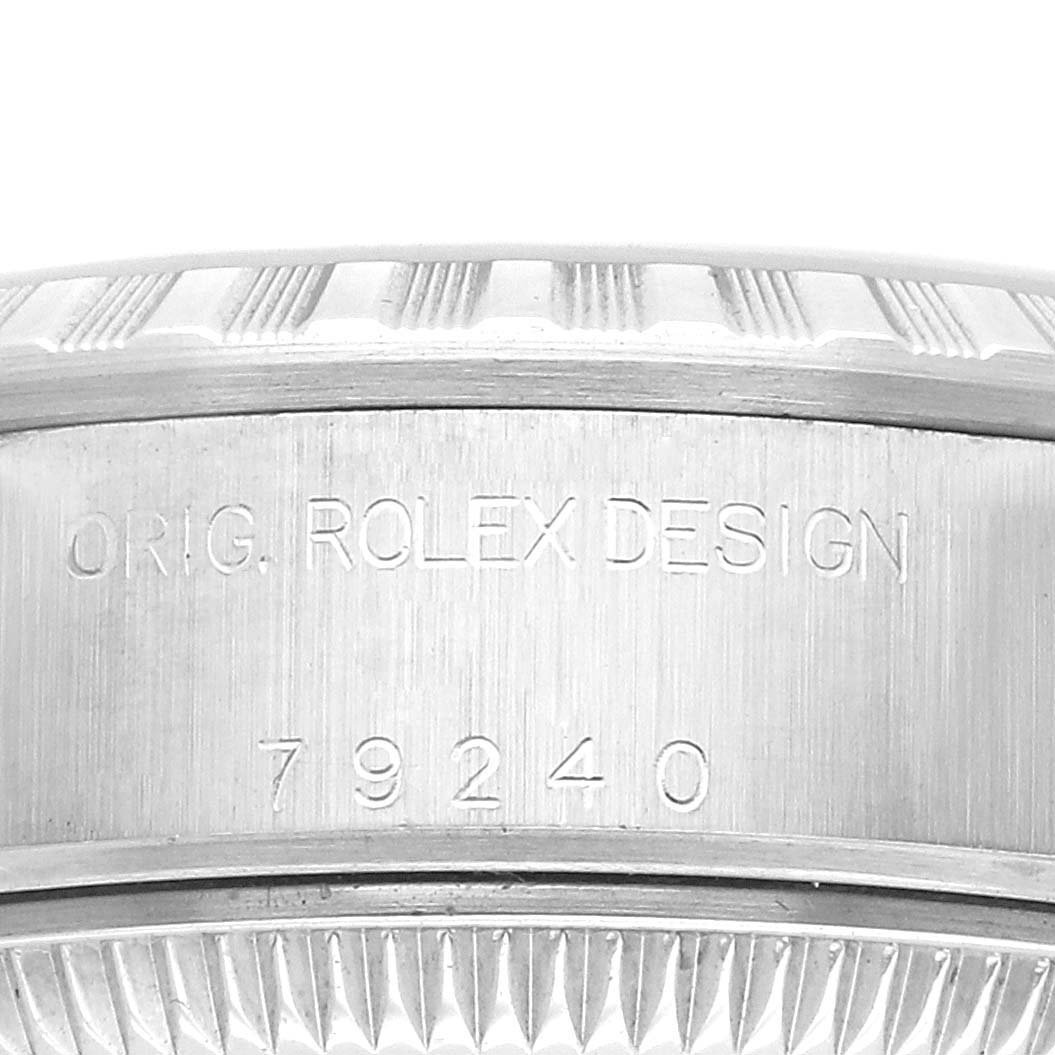 The image shows the side view of a Rolex Datejust 79240 Women
s Stainless Steel Silver Dial 79240 Women
s Stainless Steel Silver Dial case with engraved design details and model number.