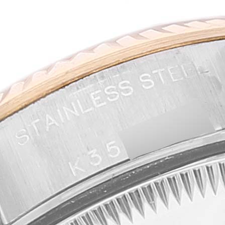 This close-up image of the Rolex Datejust 79173 Women
s Steel and Gold (two tone) Grey Dial 79173 Women
s Steel and Gold (two tone) Grey Dial watch shows part of the bezel and the "Stainless Steel" engraving on the case.