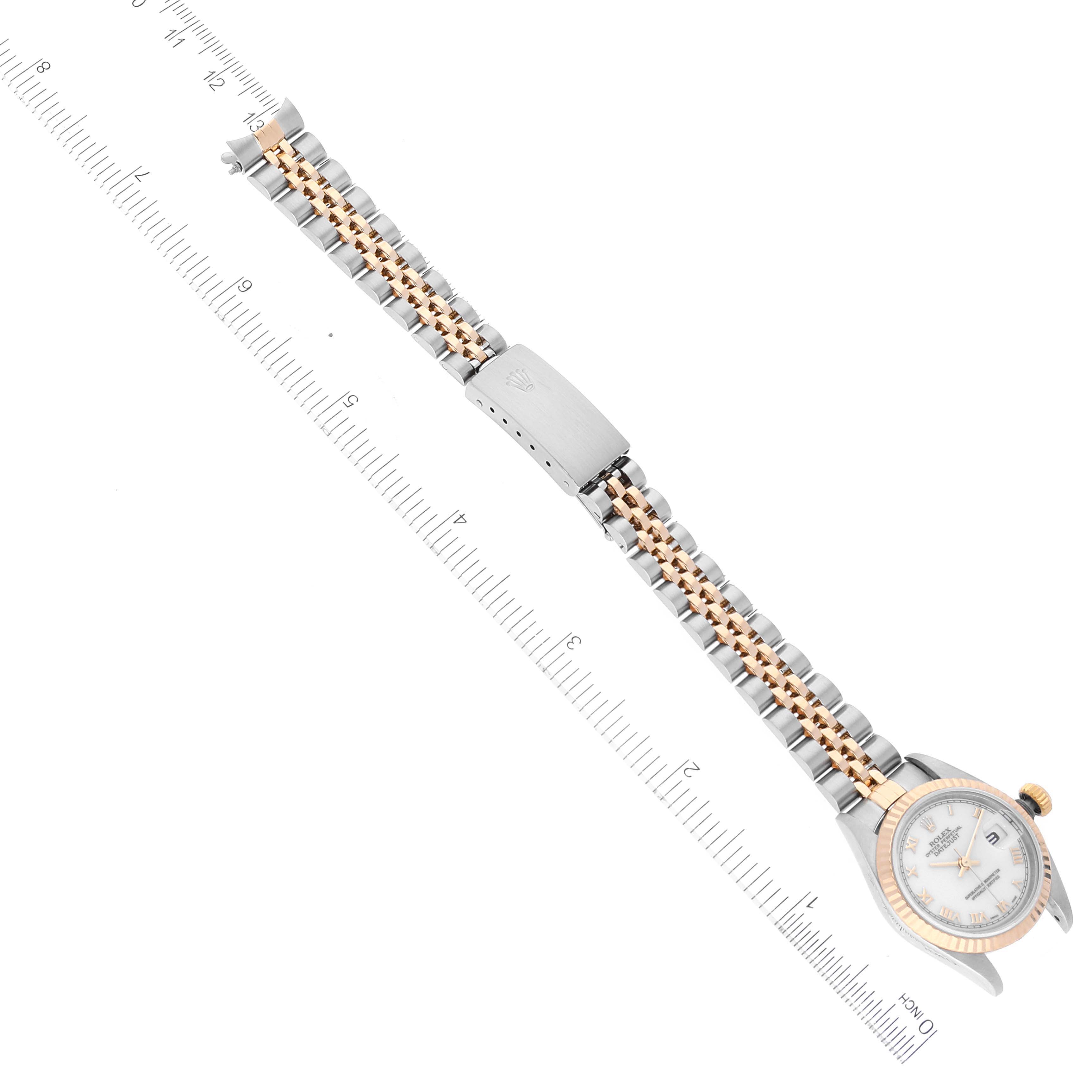 The image shows a top view of a Rolex Datejust 79173 Women
s Steel and Gold (two tone) White Dial 79173 Women
s Steel and Gold (two tone) White Dial model watch, including its two-tone bracelet and clasp.