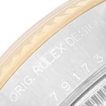 The image shows a partial view of the case back and edge of the bezel of a Rolex Datejust 79173 Women
s Steel and Gold (two tone) White Dial 79173 Women
s Steel and Gold (two tone) White Dial watch.