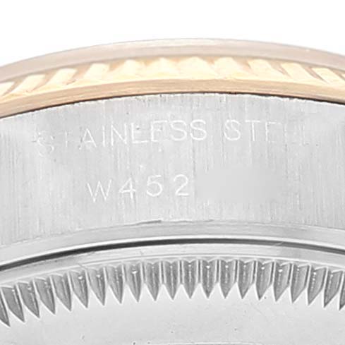 This close-up image shows the fluted bezel and part of the case back of a Rolex Datejust 69173 Women
s Steel and Gold (two tone) Champagne Dial 69173 Women
s Steel and Gold (two tone) Champagne Dial watch.